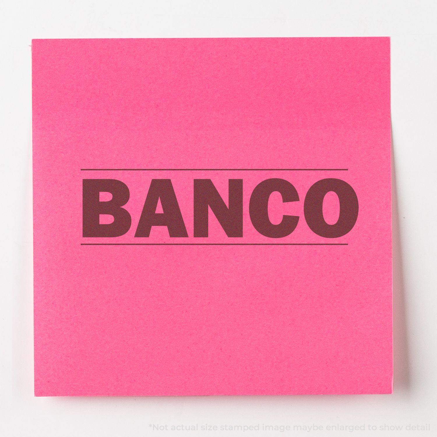 Bold Banco Rubber Stamp impression on a bright pink sticky note, showcasing the word BANCO in large, bold letters.