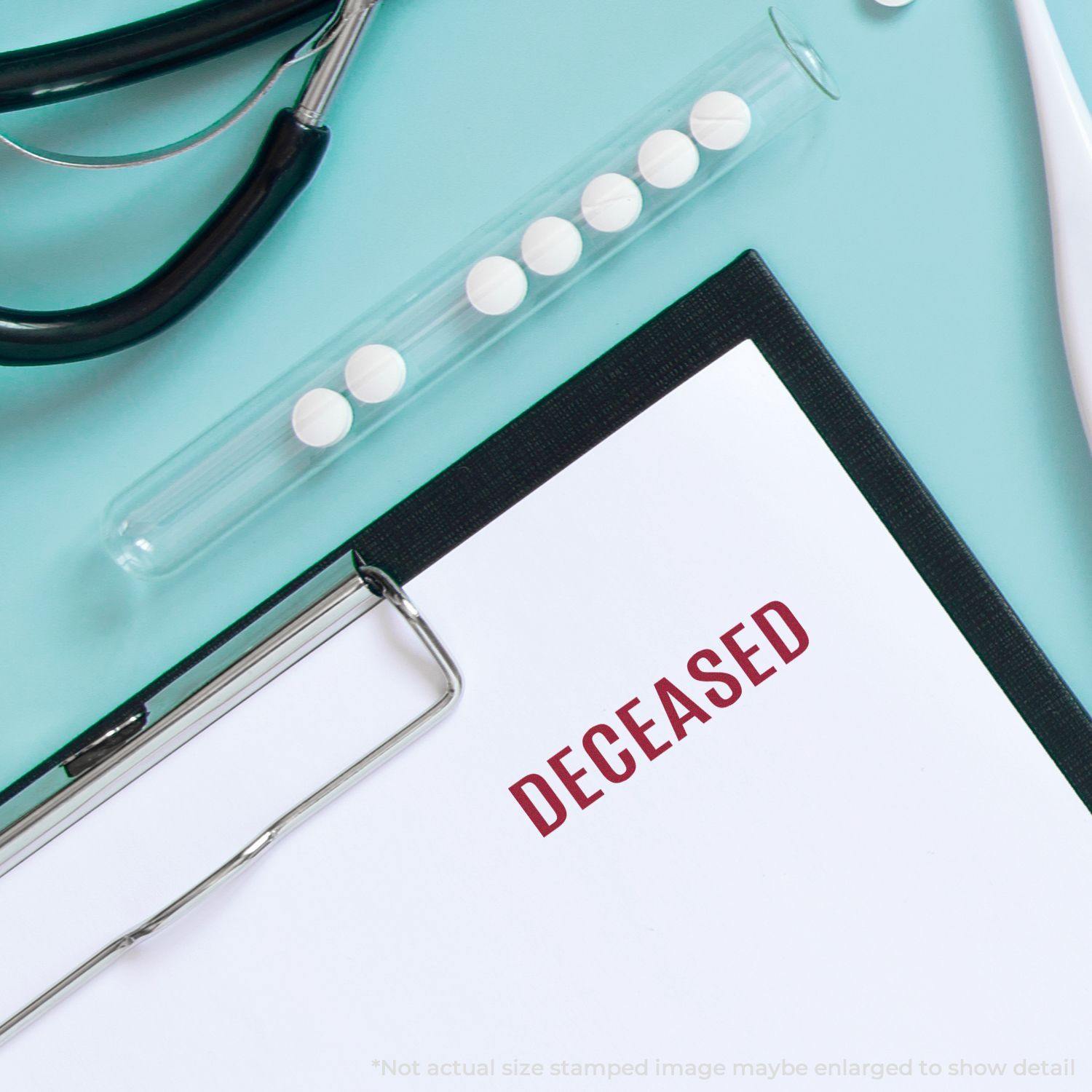 Clipboard with DECEASED stamped in red using the Large Self Inking Bold Deceased Stamp, next to medical tools and pills on a blue surface.