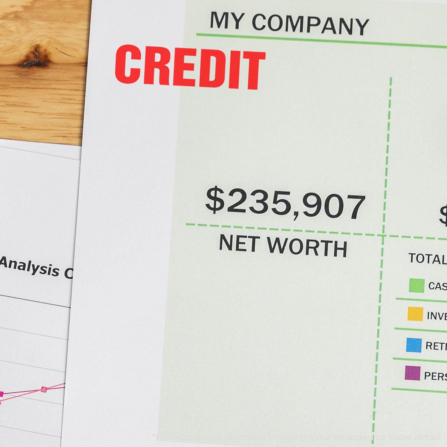 Bold Red Credit Rubber Stamp on a financial document showing a net worth of $235,907 with charts and graphs in the background.