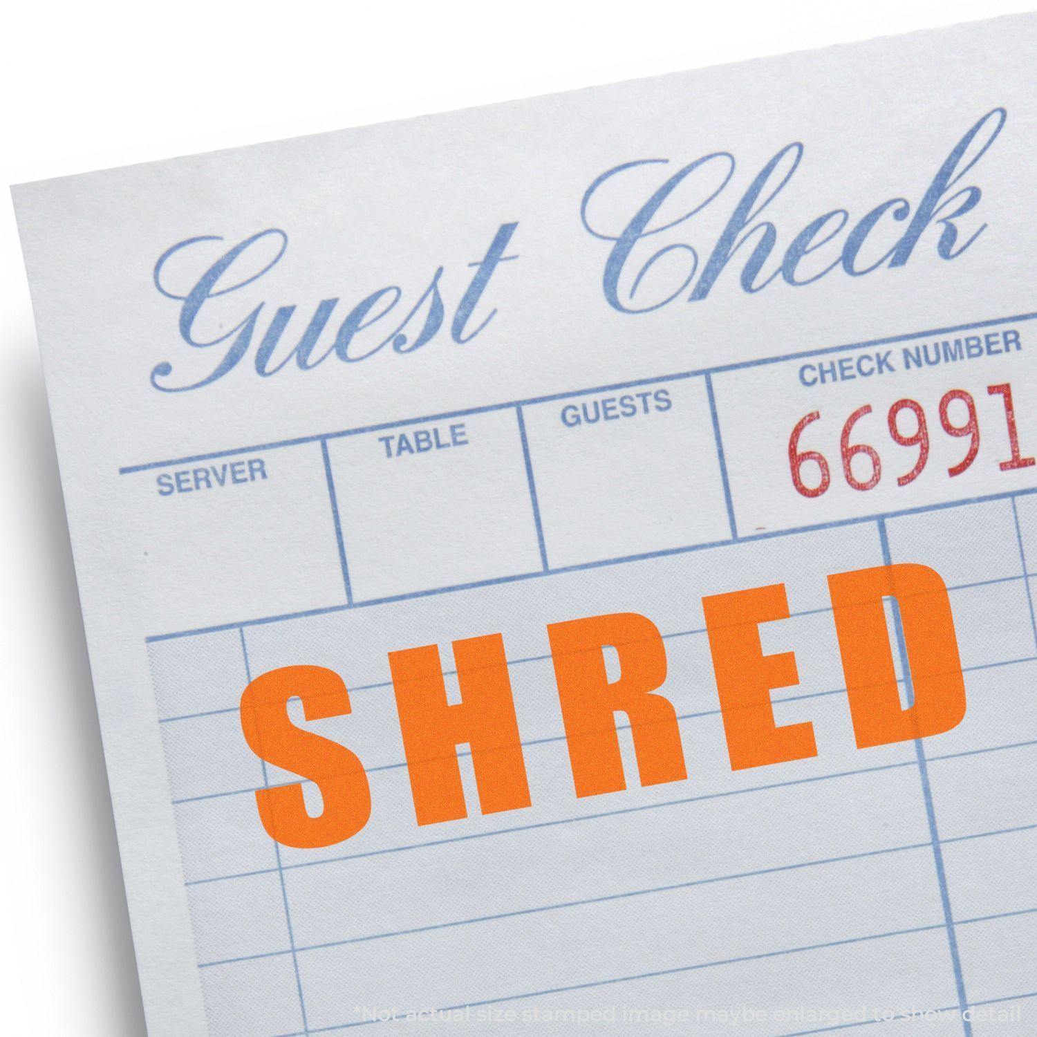 Guest check stamped with "SHRED" in bold orange letters using the Slim Pre-Inked Bold Shred Stamp.