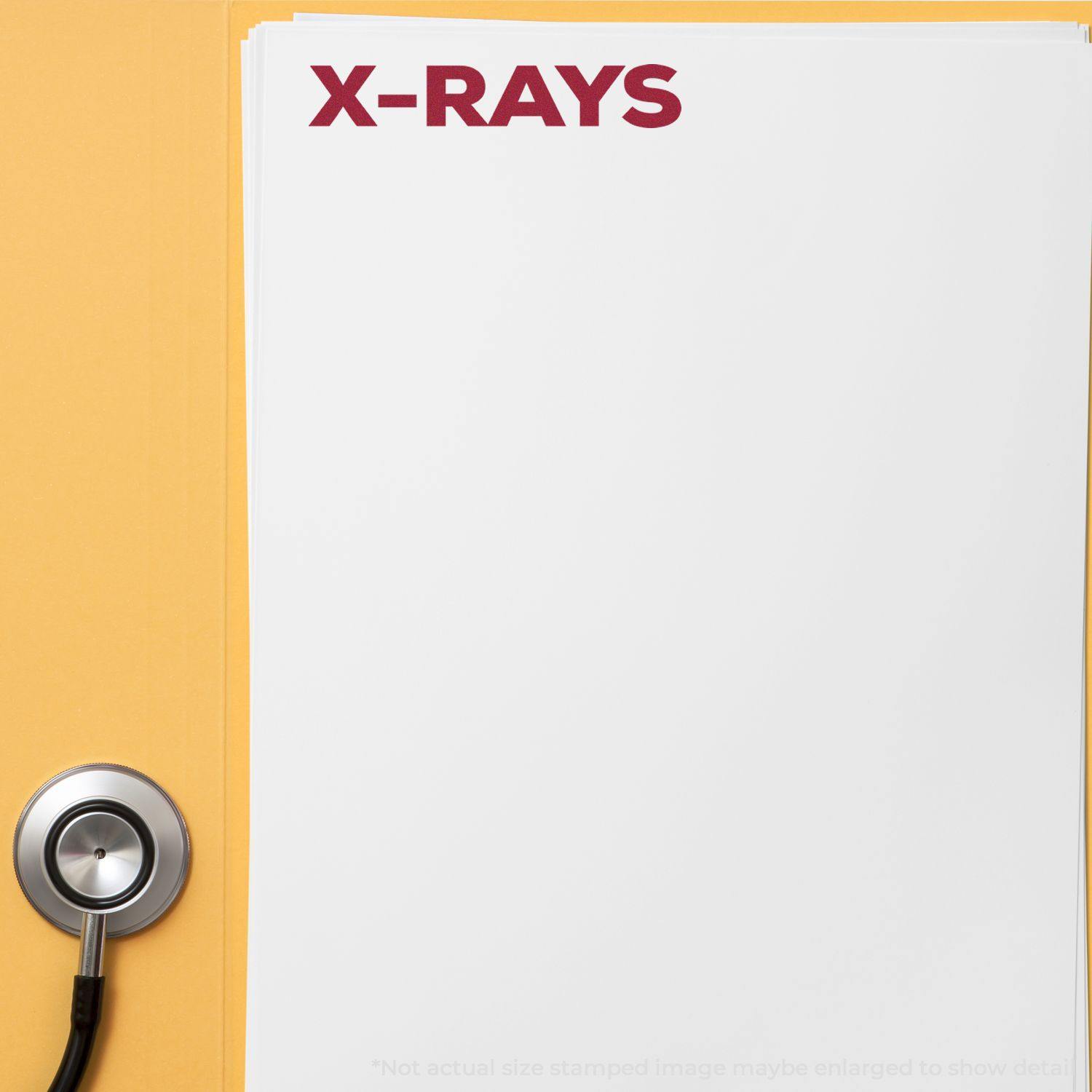 A stack of papers stamped with X-RAYS in bold red using the Self Inking Bold X-Rays Stamp, next to a stethoscope on a yellow background.