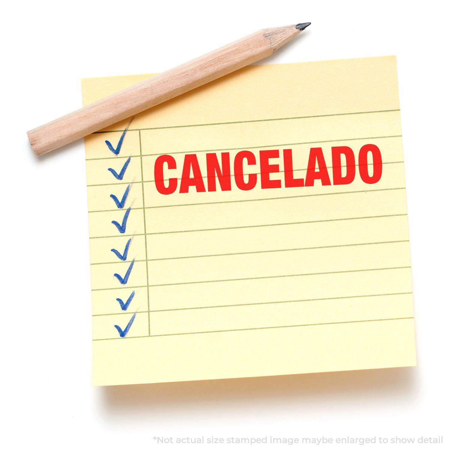 A yellow notepad with blue checkmarks and the word CANCELADO stamped in red using a Self Inking Cancelado Stamp, with a pencil on top.