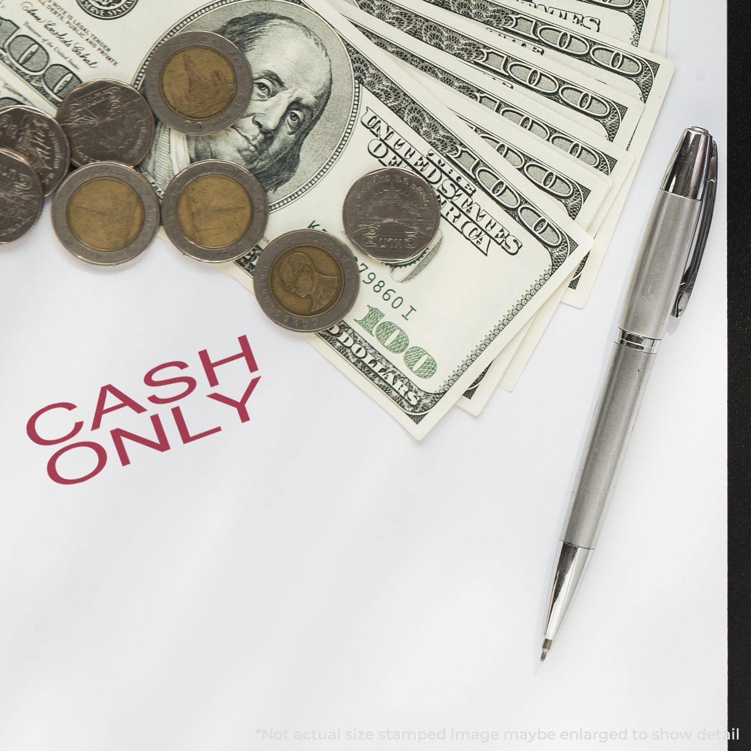 A desk with a pen, coins, dollar bills, and a paper stamped with CASH ONLY using the Large Self Inking Cash Only Stamp.