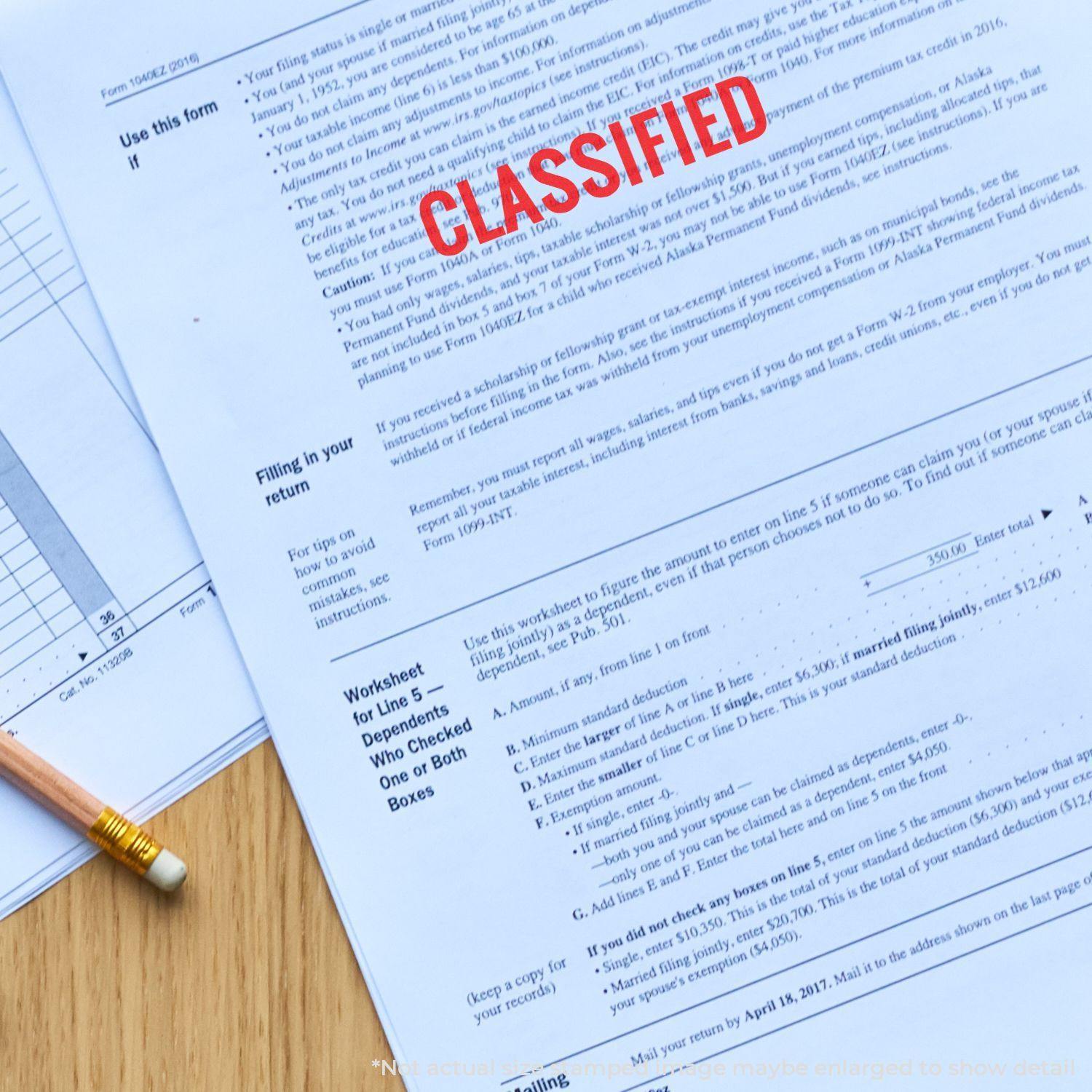 A document stamped with Classified using a Classified Rubber Stamp, placed on a wooden desk with a pencil and additional papers.