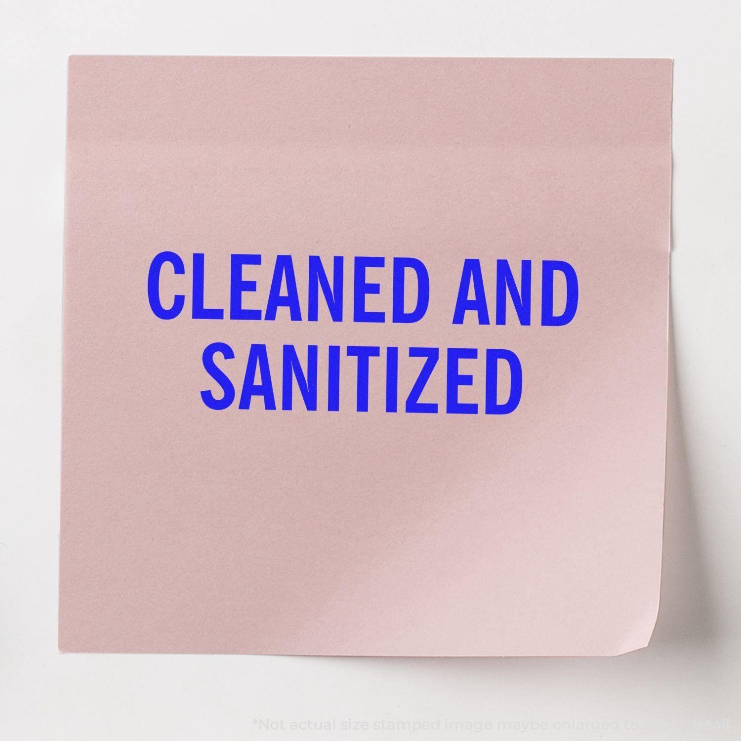 A pink paper with the text CLEANED AND SANITIZED in blue, stamped using the Large Self Inking Cleaned and Sanitized Stamp.