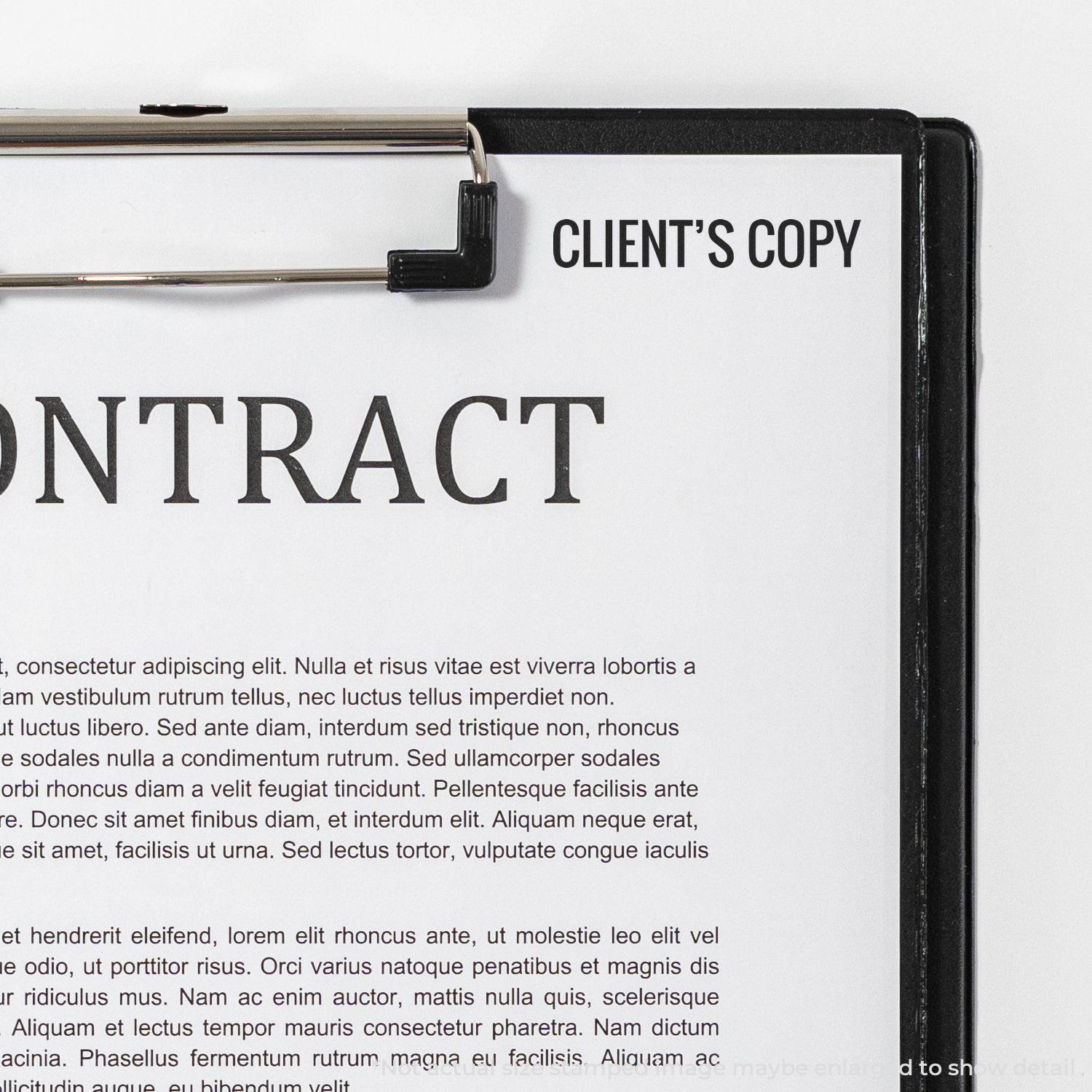 A Large Self Inking Client's Copy Stamp is used on a contract document clipped to a clipboard, with the text CLIENT'S COPY visible.