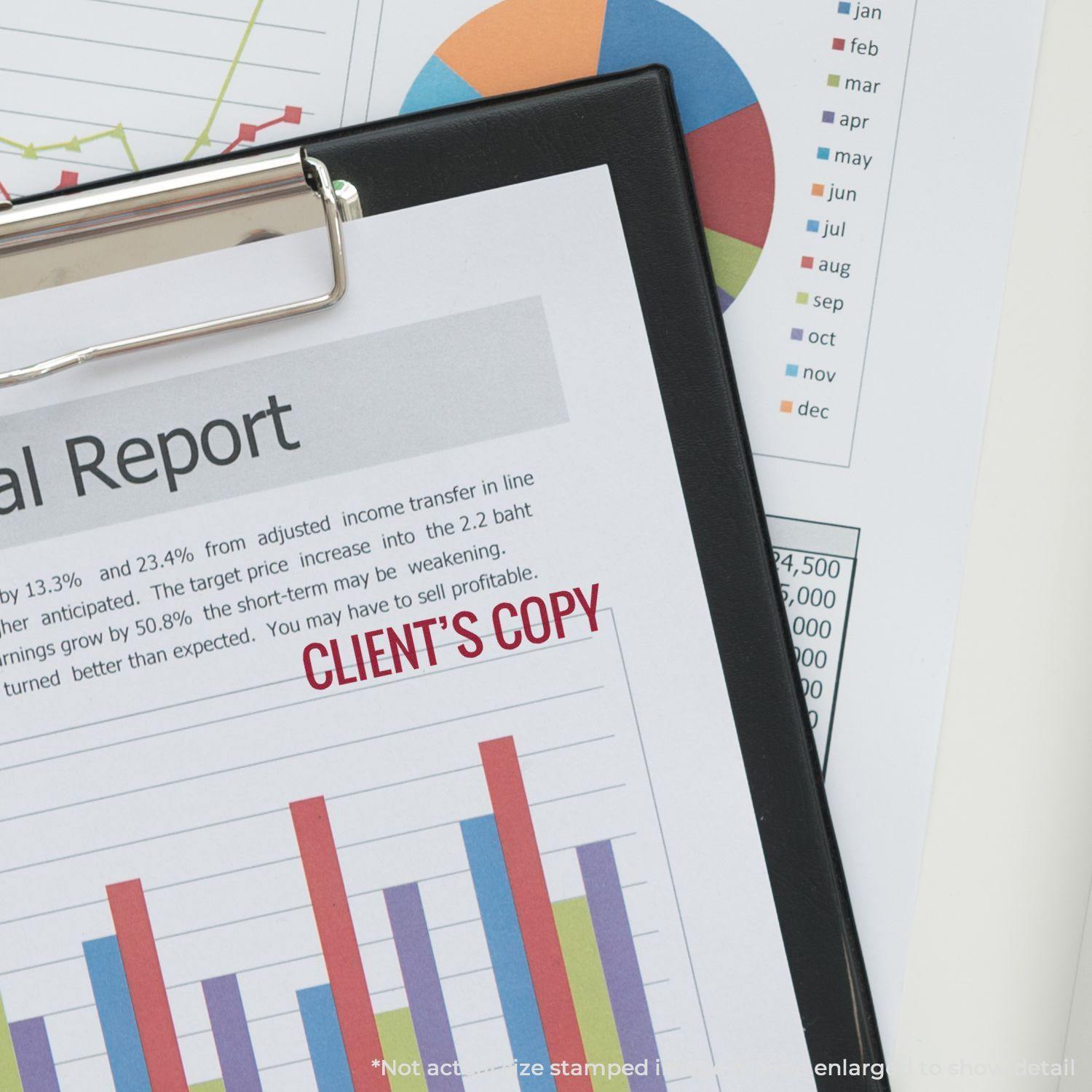 A financial report stamped with CLIENT'S COPY using a Self Inking Client's Copy Stamp, placed on a clipboard with charts in the background.