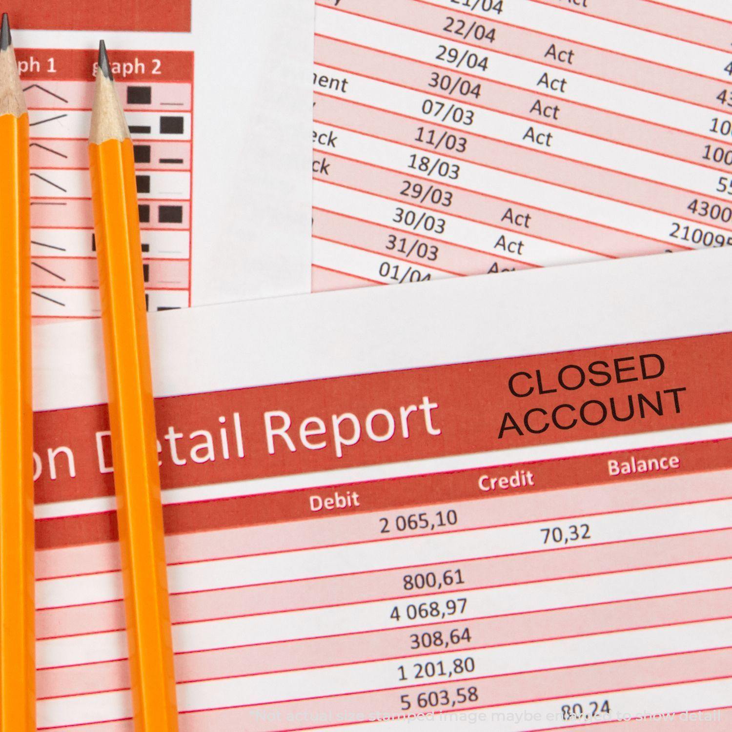 Two pencils rest on financial documents stamped with CLOSED ACCOUNT using the Large Self Inking Closed Account Stamp.