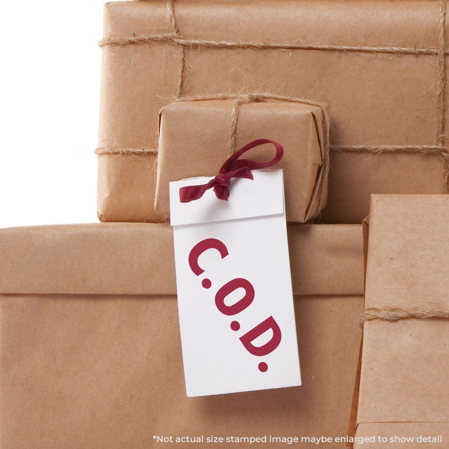 Packages wrapped in brown paper with a tag stamped C.O.D. using the Large Self Inking COD Office Stamp.