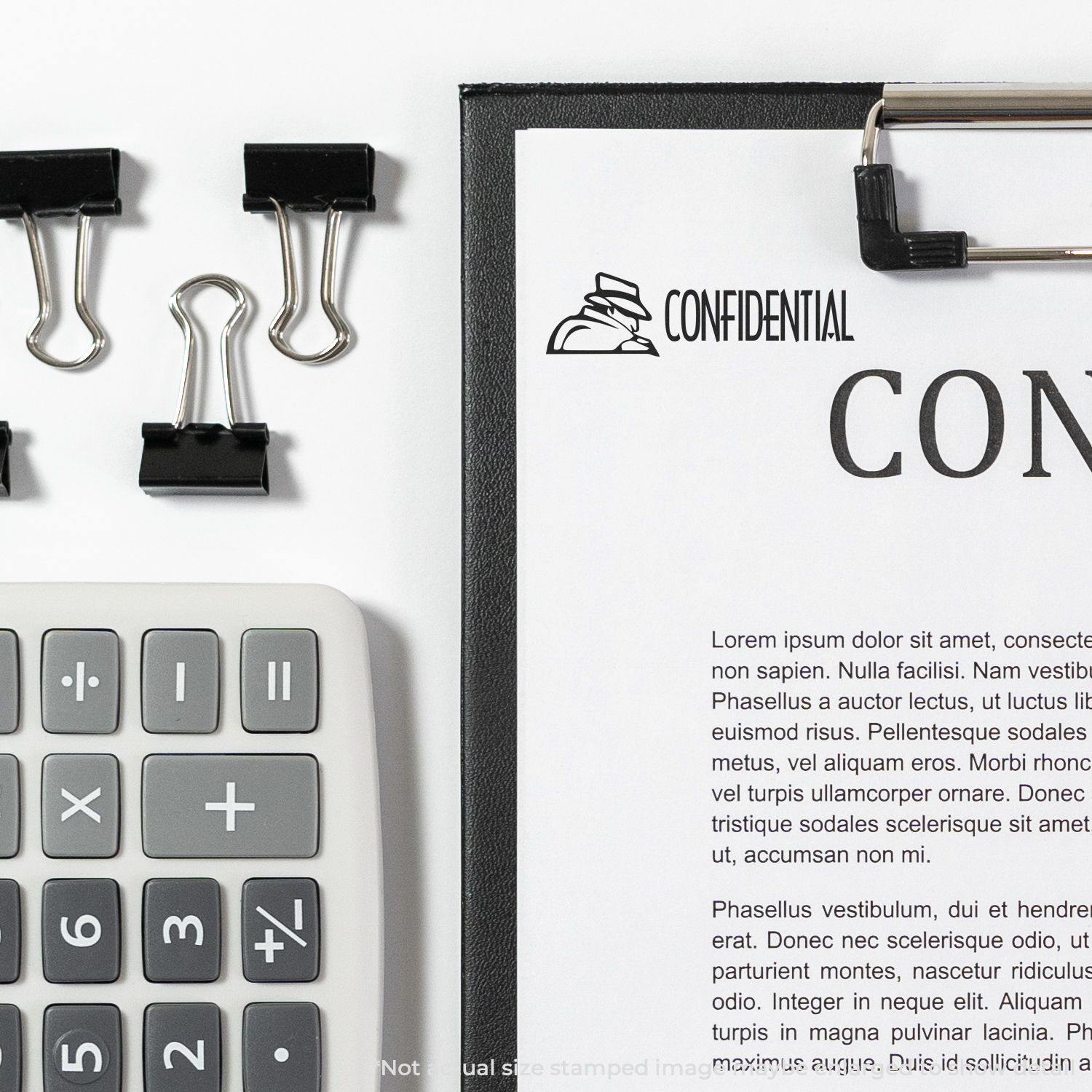 A clipboard with a document stamped Confidential with Logo Rubber Stamp, surrounded by a calculator and binder clips.