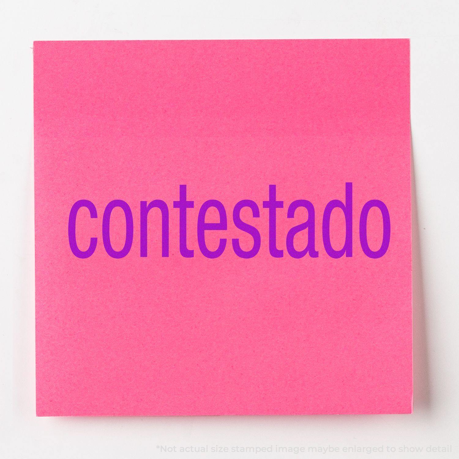 Slim Pre-Inked Contestado Stamp used on a bright pink sticky note, displaying the word contestado in bold purple letters.