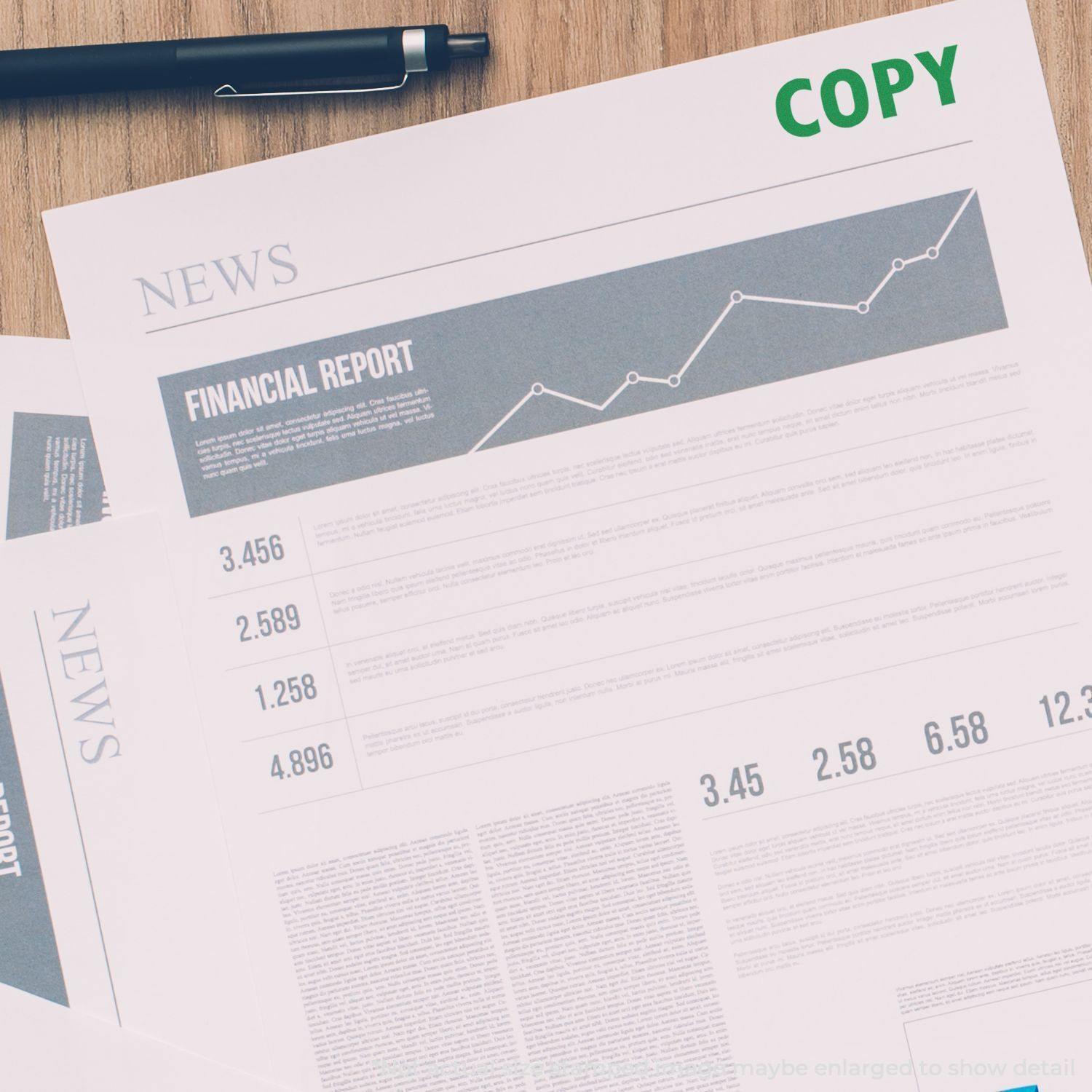 A financial report stamped with COPY in green ink using a Copy Rubber Stamp, with a pen placed on top of the document.