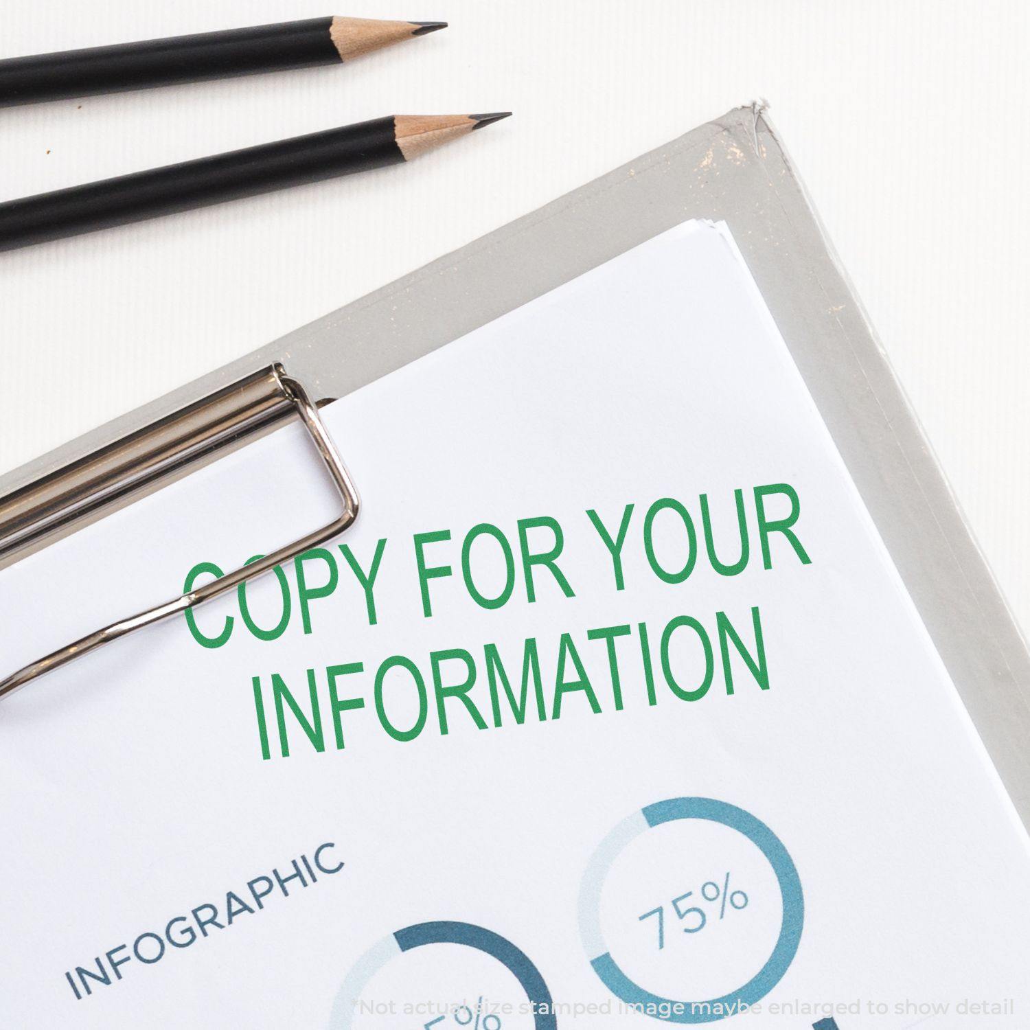 Clipboard with a document stamped Copy For Your Information in green ink, next to two pencils on a white surface.