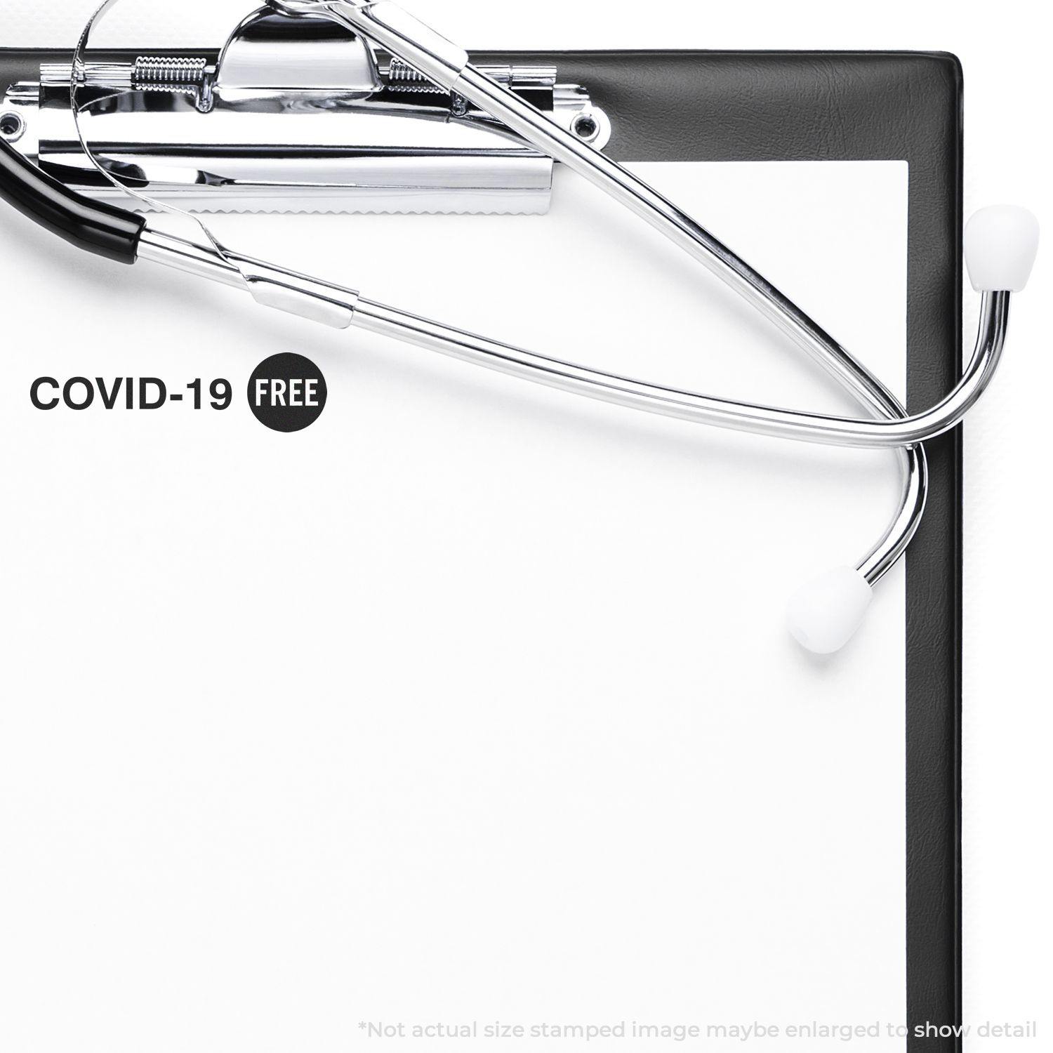 A self-inking stamp with a stamped image showing how the text "COVID-19" with a "FREE" signboard on the right is displayed after stamping.
