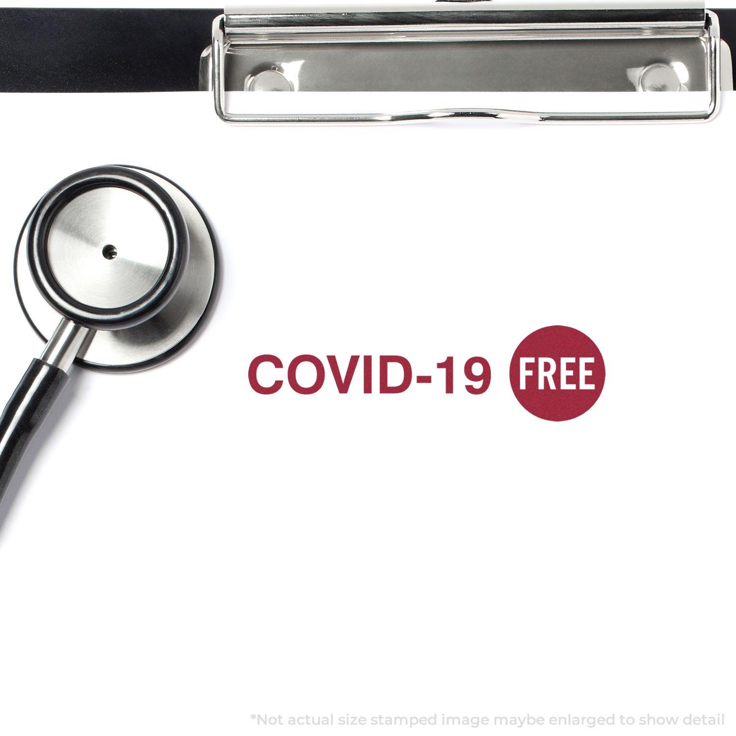 A stethoscope and clipboard with a COVID-19 FREE mark from the Large Pre-Inked Covid-19 Stamp in red ink.