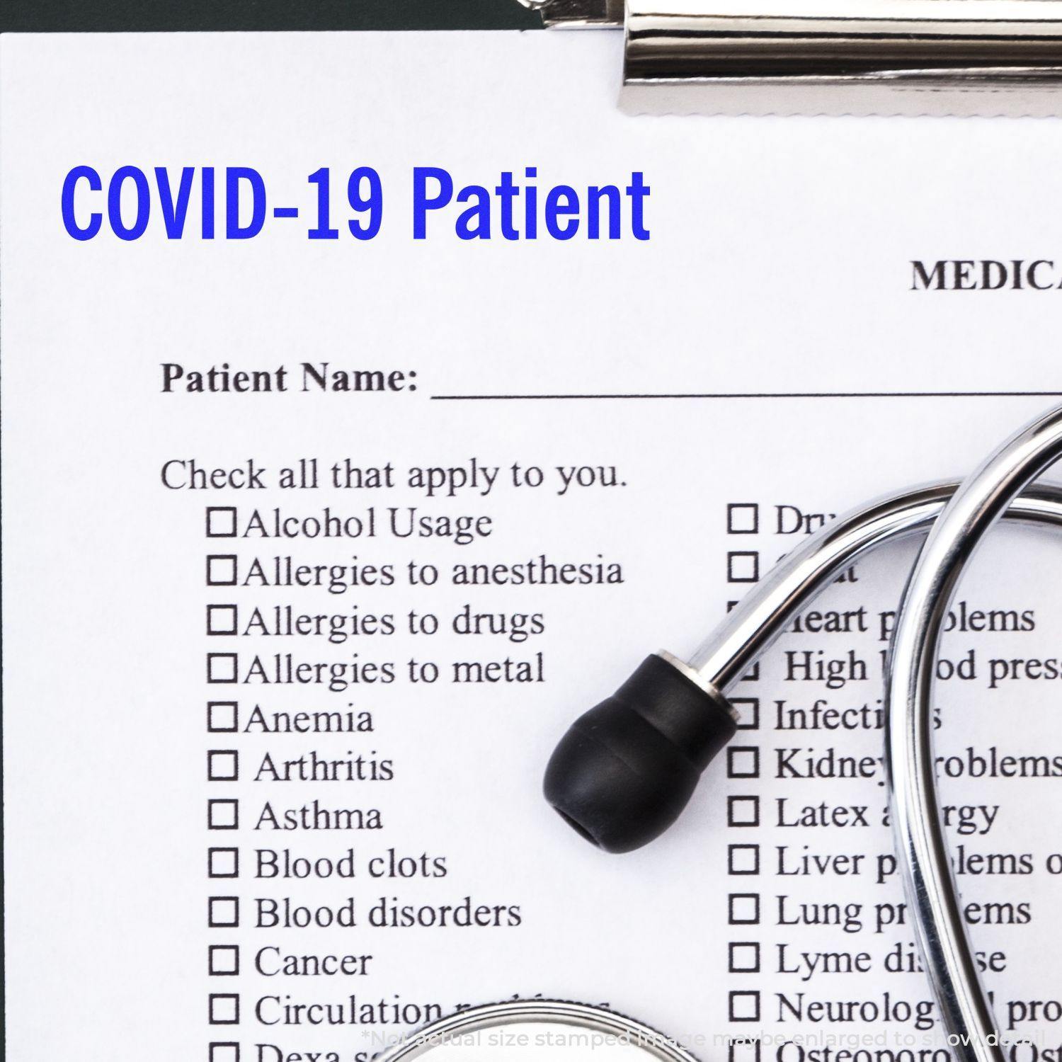 A Large Covid-19 Patient Rubber Stamp marks a medical form with COVID-19 Patient in blue text, next to a stethoscope on a clipboard.