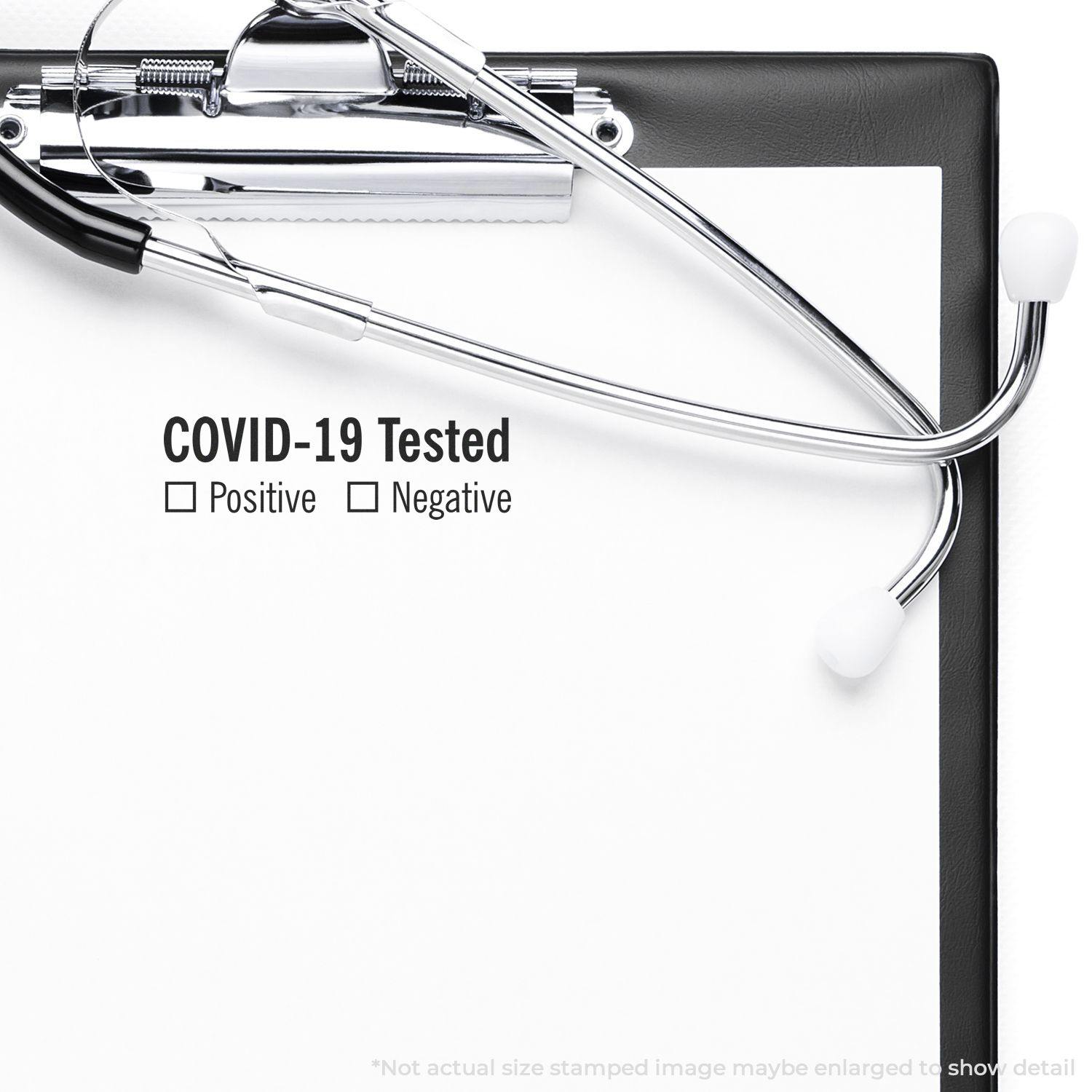 A self-inking stamp with a stamped image showing how the text "COVID-19 Tested" with the words "Positive" and "Negative" underneath with checkboxes (where a box can be checked based on whether a person is positive or negative for the virus) is displayed after stamping.