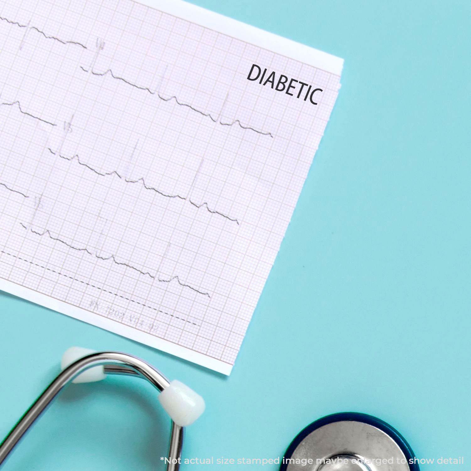 A medical chart stamped with DIABETIC using the Diabetic Rubber Stamp, placed next to a stethoscope on a light blue surface.