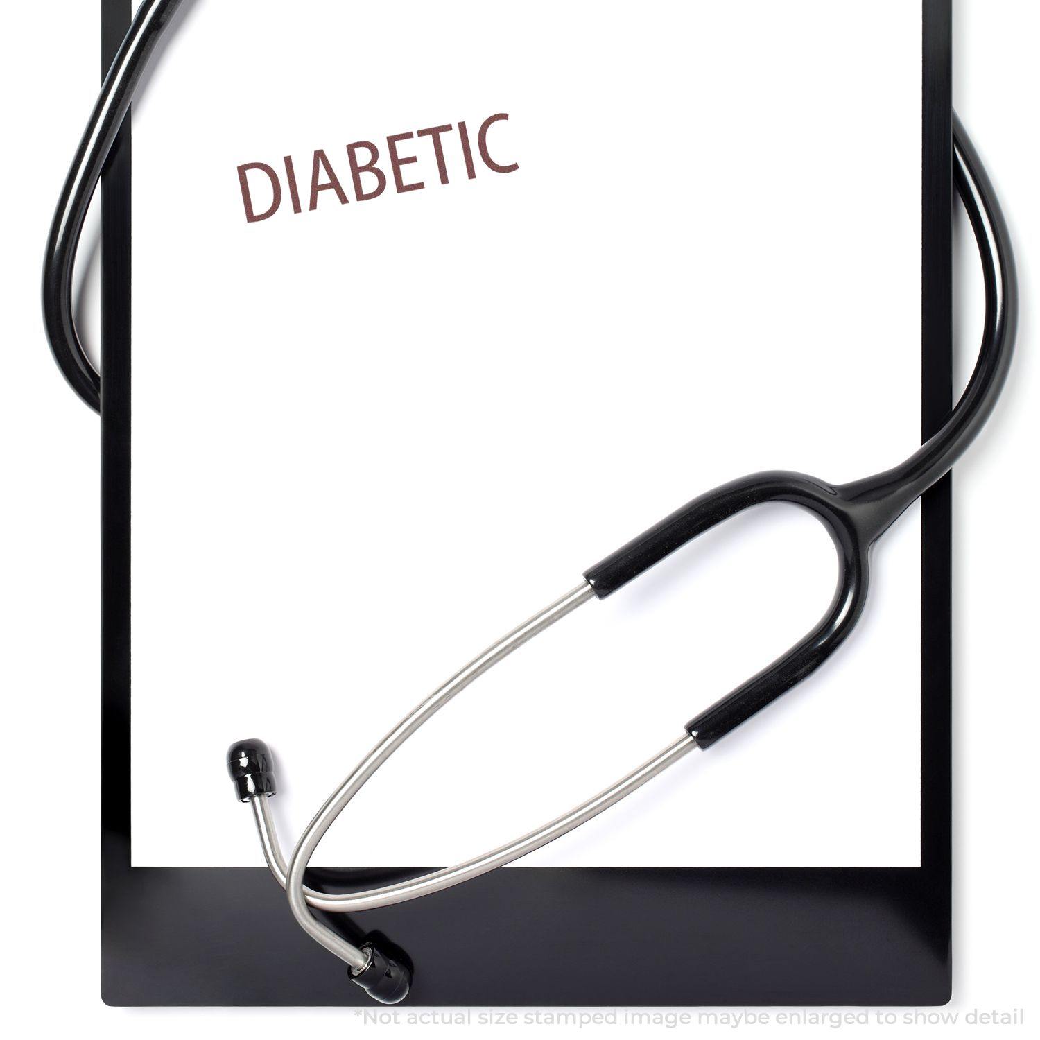 A clipboard with a stethoscope and a paper stamped with DIABETIC using the Diabetic Rubber Stamp.