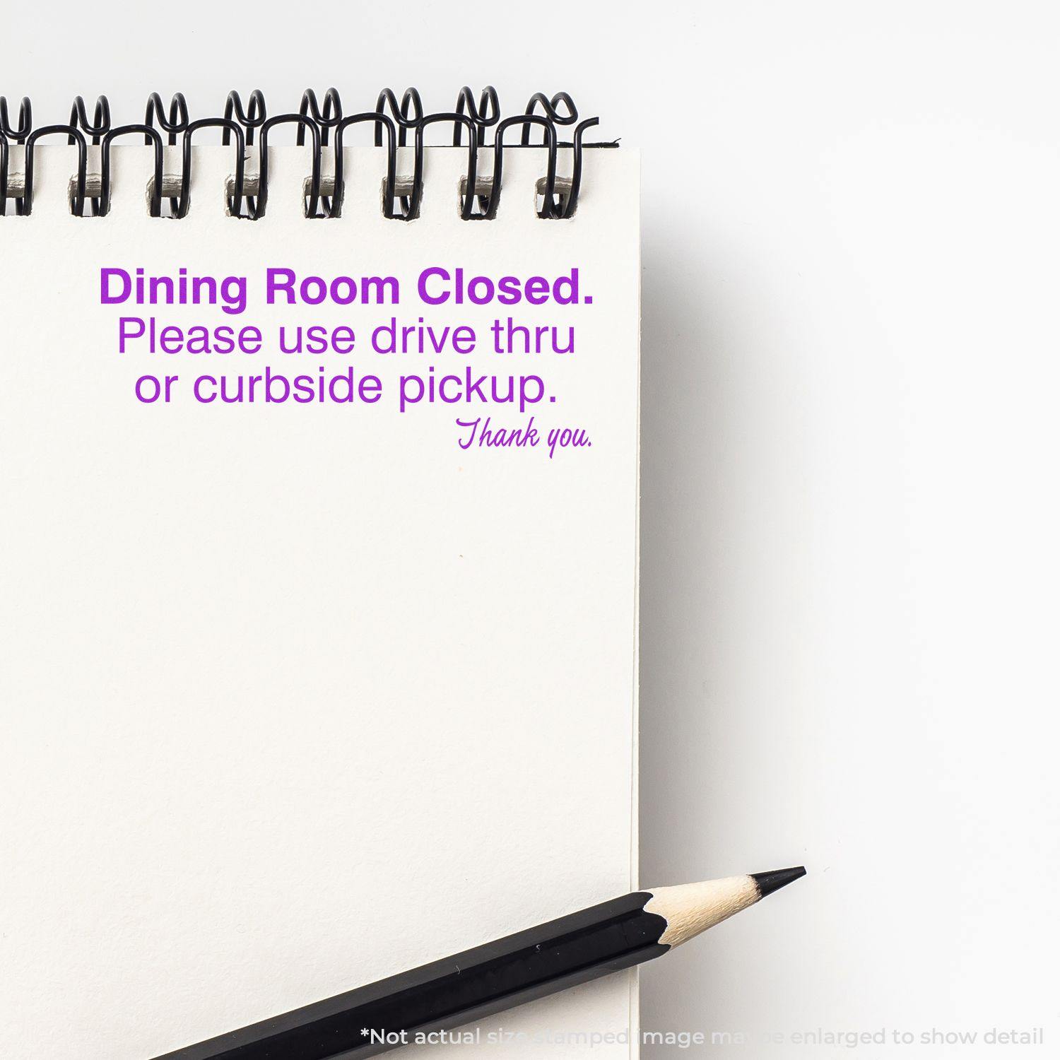 A notebook with a Dining Room Closed message stamped in purple ink using the Large Dining Room Closed Rubber Stamp, next to a pencil.