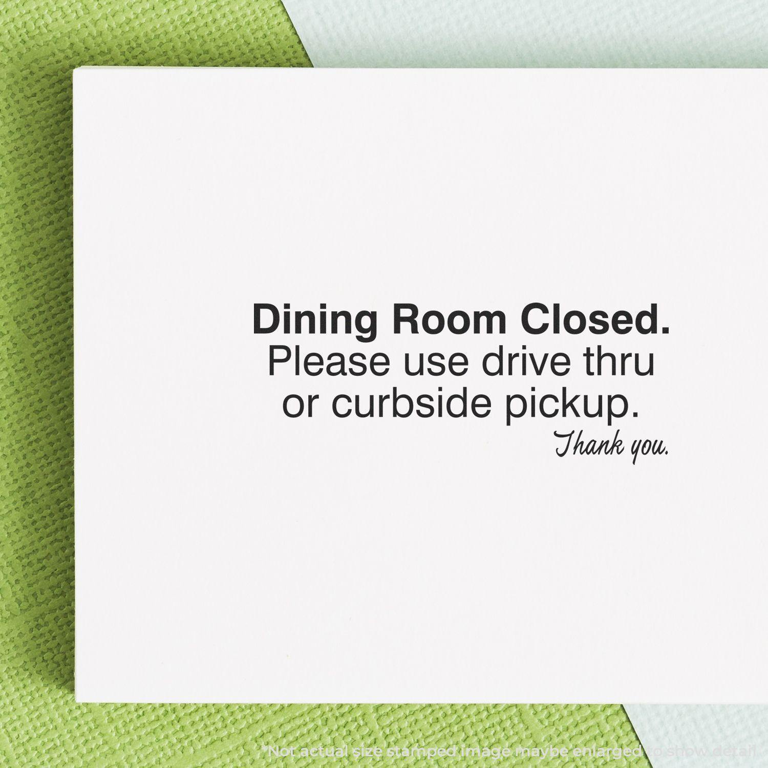 Self Inking Dining Room Closed Stamp used on a white paper with green textured background, indicating drive-thru or curbside pickup options.