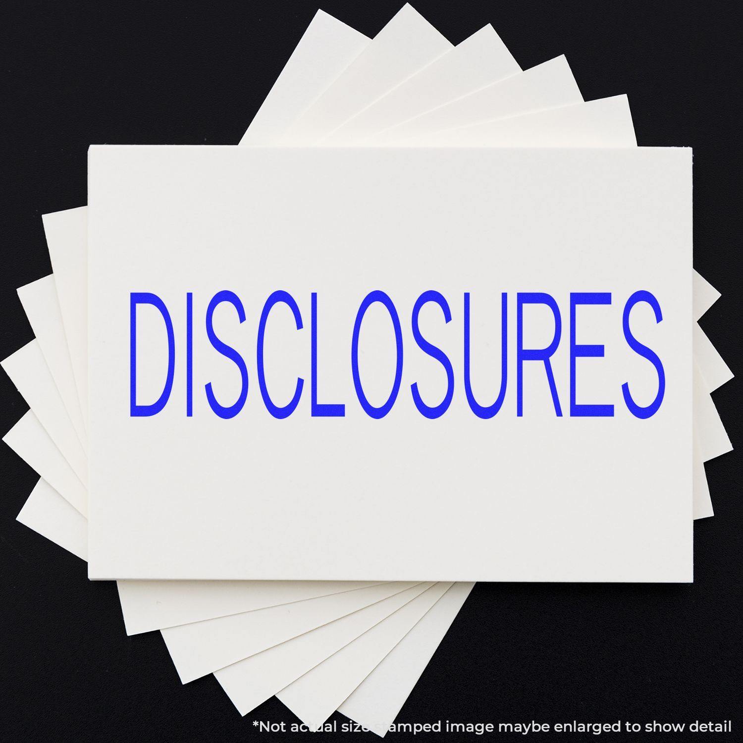 Disclosures Rubber Stamp in use, showing the word 'DISCLOSURES' stamped in blue on a white card, with multiple cards fanned out underneath.