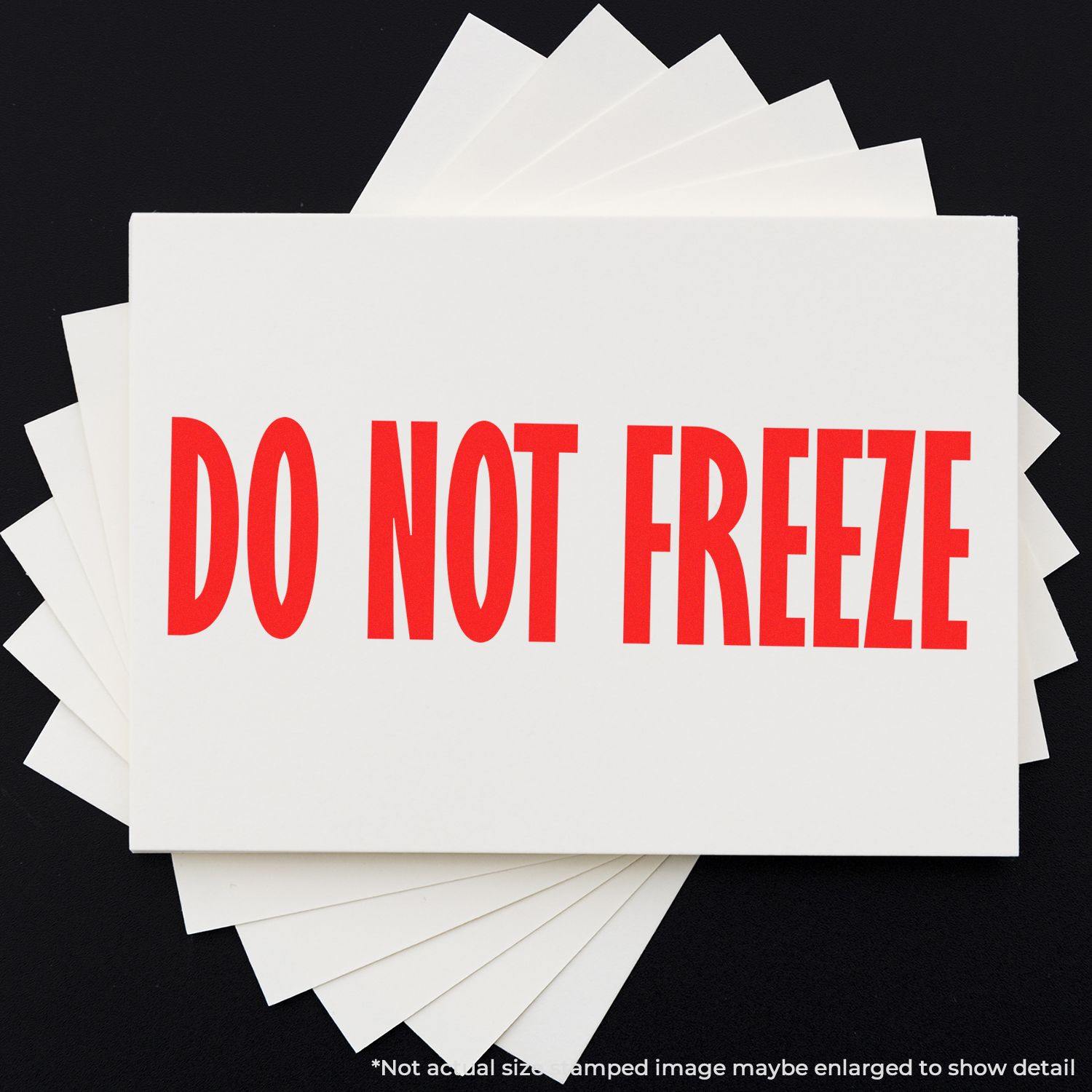 Large Do Not Freeze Rubber Stamp in red ink on white paper, displayed on a black background with multiple sheets underneath.