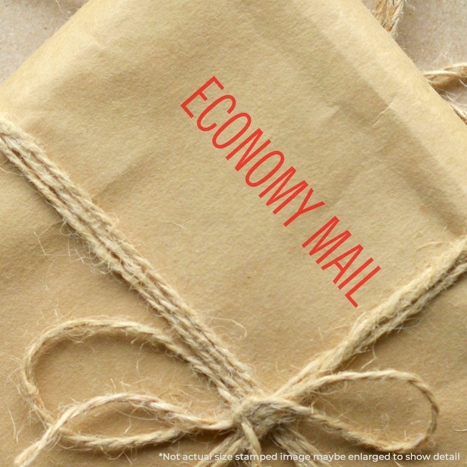 A brown package tied with twine, stamped with ECONOMY MAIL in red using the Economy Mail Rubber Stamp.