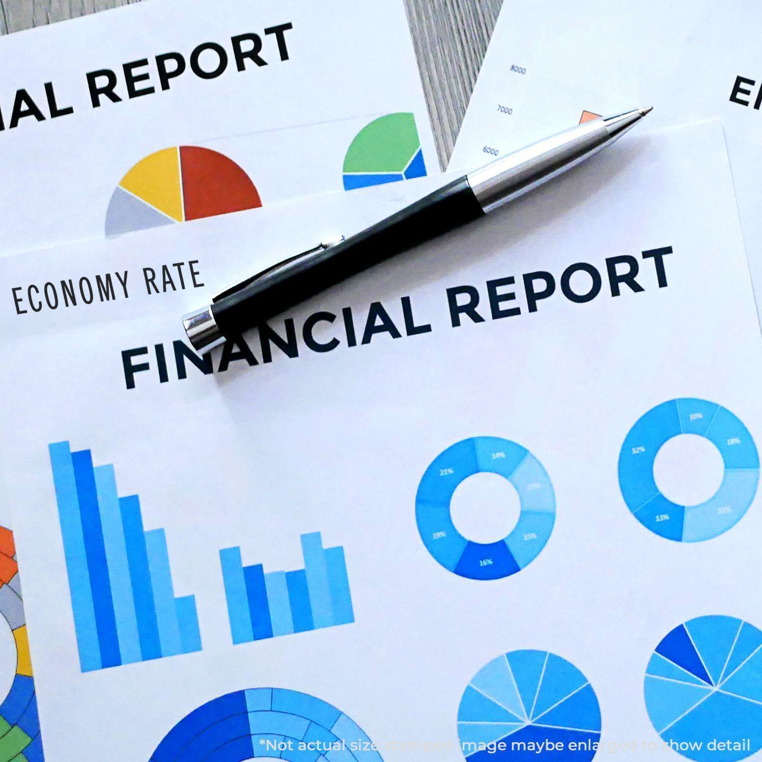 Slim Pre-Inked Economy Rate Stamp on financial report papers with colorful charts and a pen on a desk.