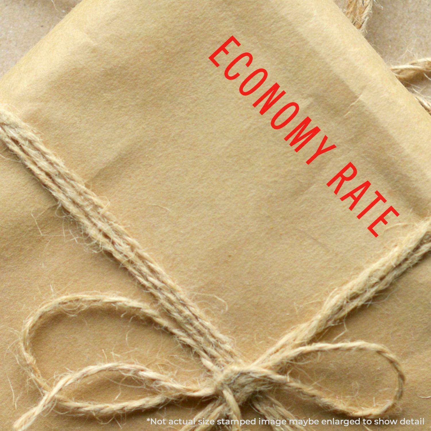 A brown package tied with twine, stamped with ECONOMY RATE in red using the Self Inking Economy Rate Stamp.