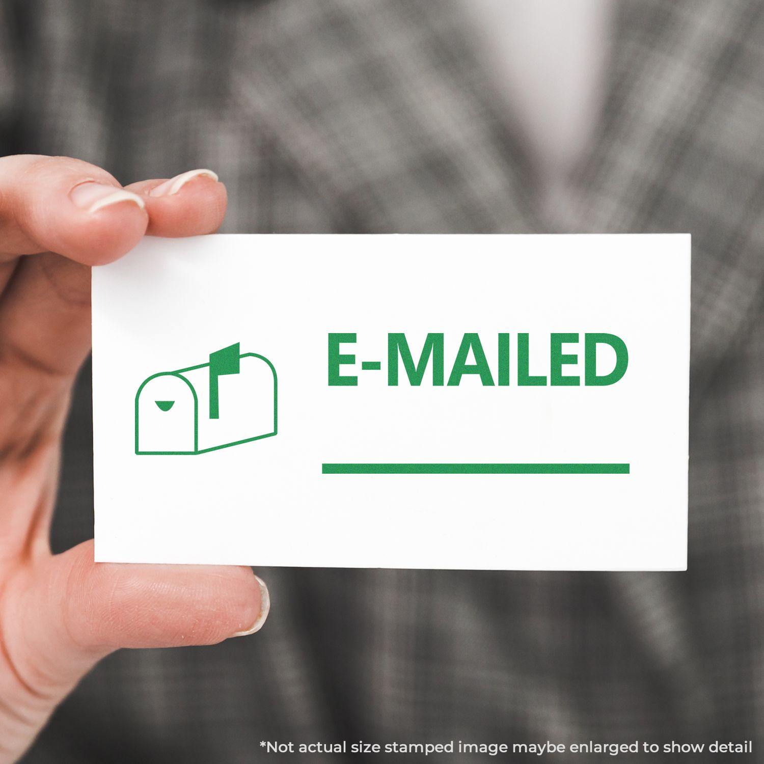 A hand holding a white card stamped with a green mailbox icon and the text E-MAILED using the Emailed with Mailbox Rubber Stamp.