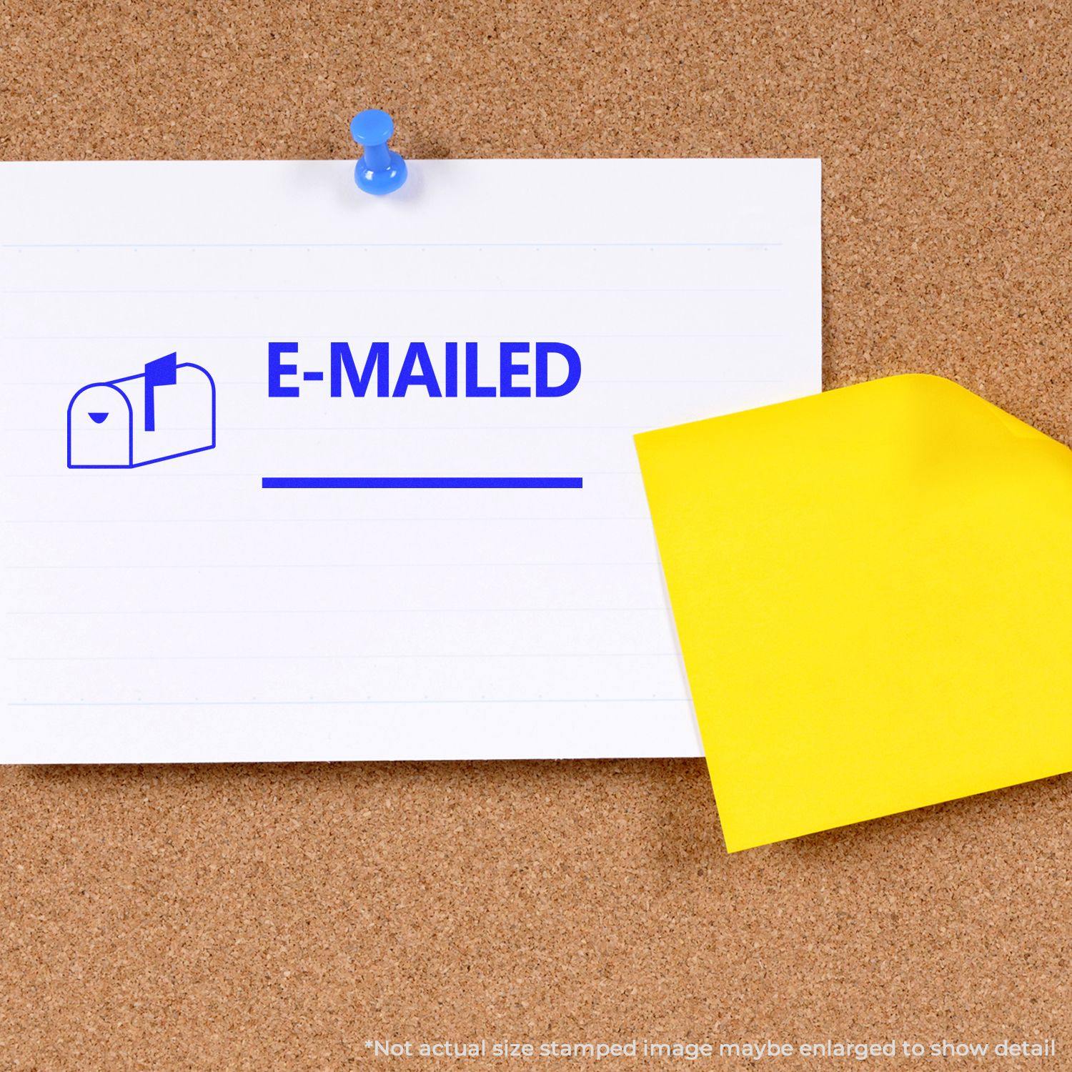 Large Emailed with Mailbox Rubber Stamp used on a white paper pinned to a corkboard, with a yellow envelope beside it.