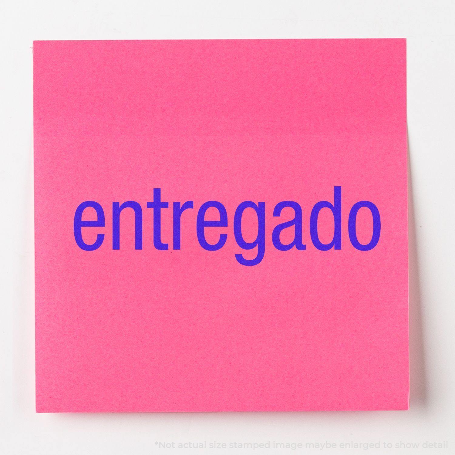 Slim Pre-Inked Entregado Stamp on a pink sticky note with the word entregado in bold blue letters.