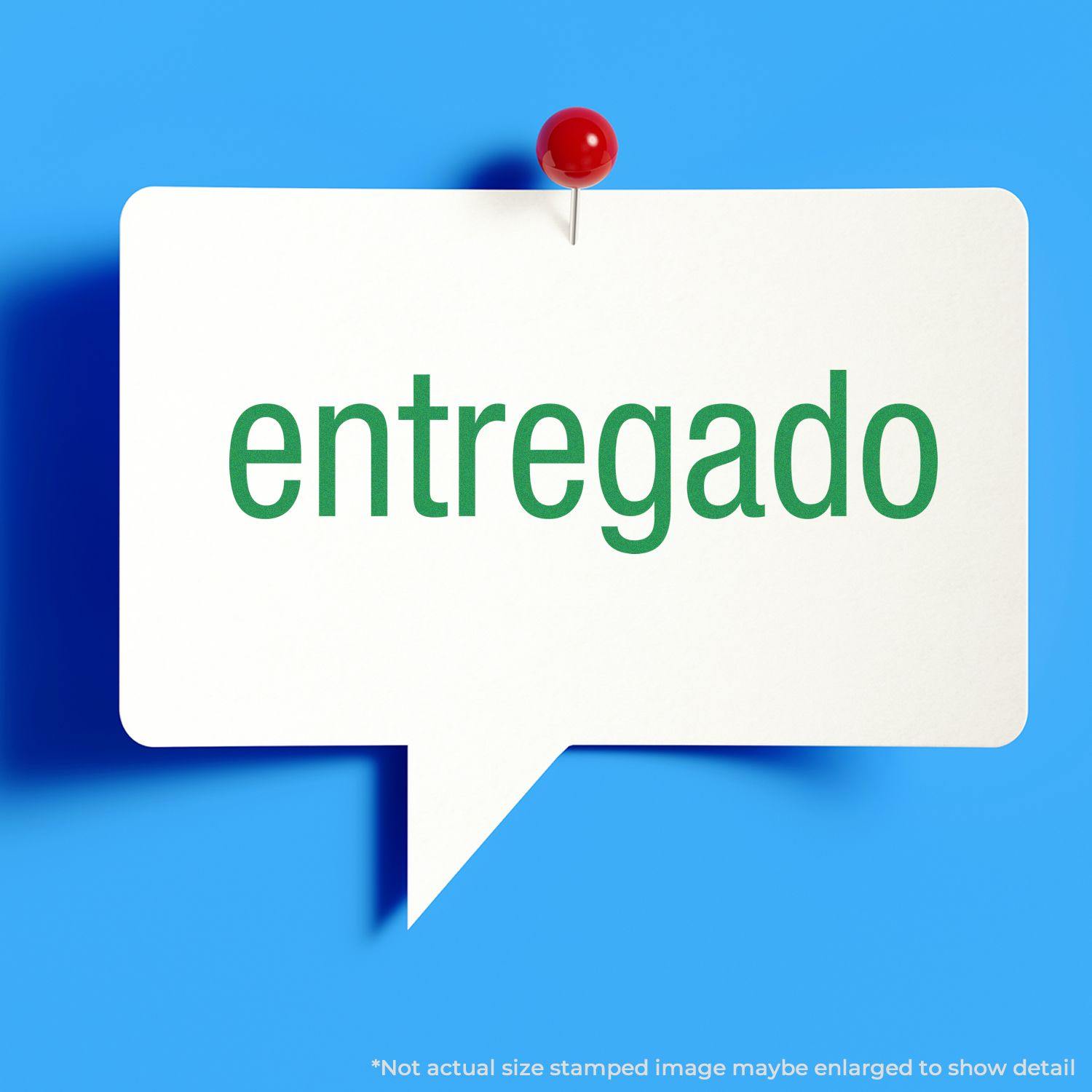 Self Inking Entregado Stamp imprint on a white speech bubble pinned to a blue background with a red pushpin.