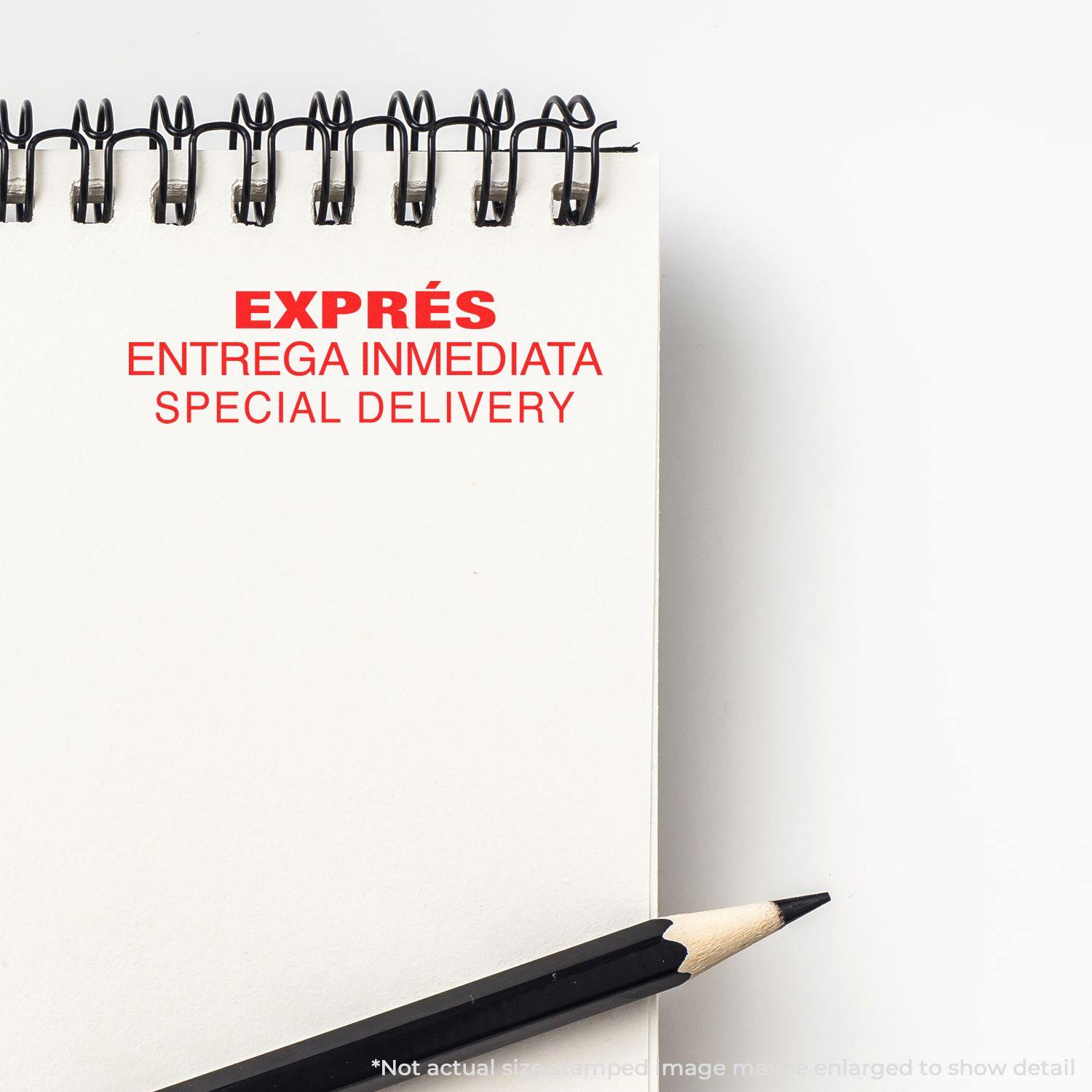 Expres Entrega Inmediata Rubber Stamp in red ink on a white notepad, with a black pencil placed beside the notepad.