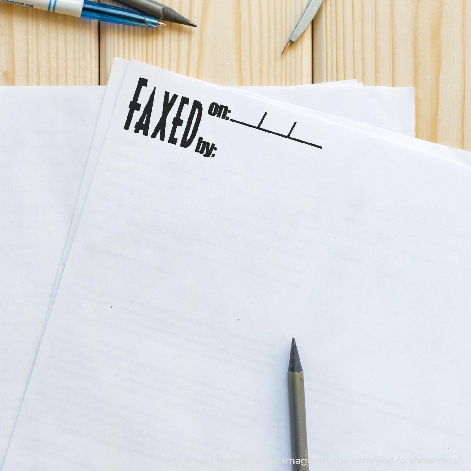 A stack of papers stamped with FAXED on: using the Faxed on Rubber Stamp, with a pen and pencil on a wooden desk.