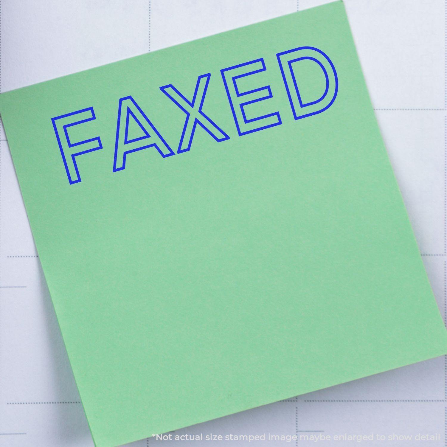 A self-inking stamp with a stamped image showing how the text "FAXED" in a large outline font is displayed by it after stamping.