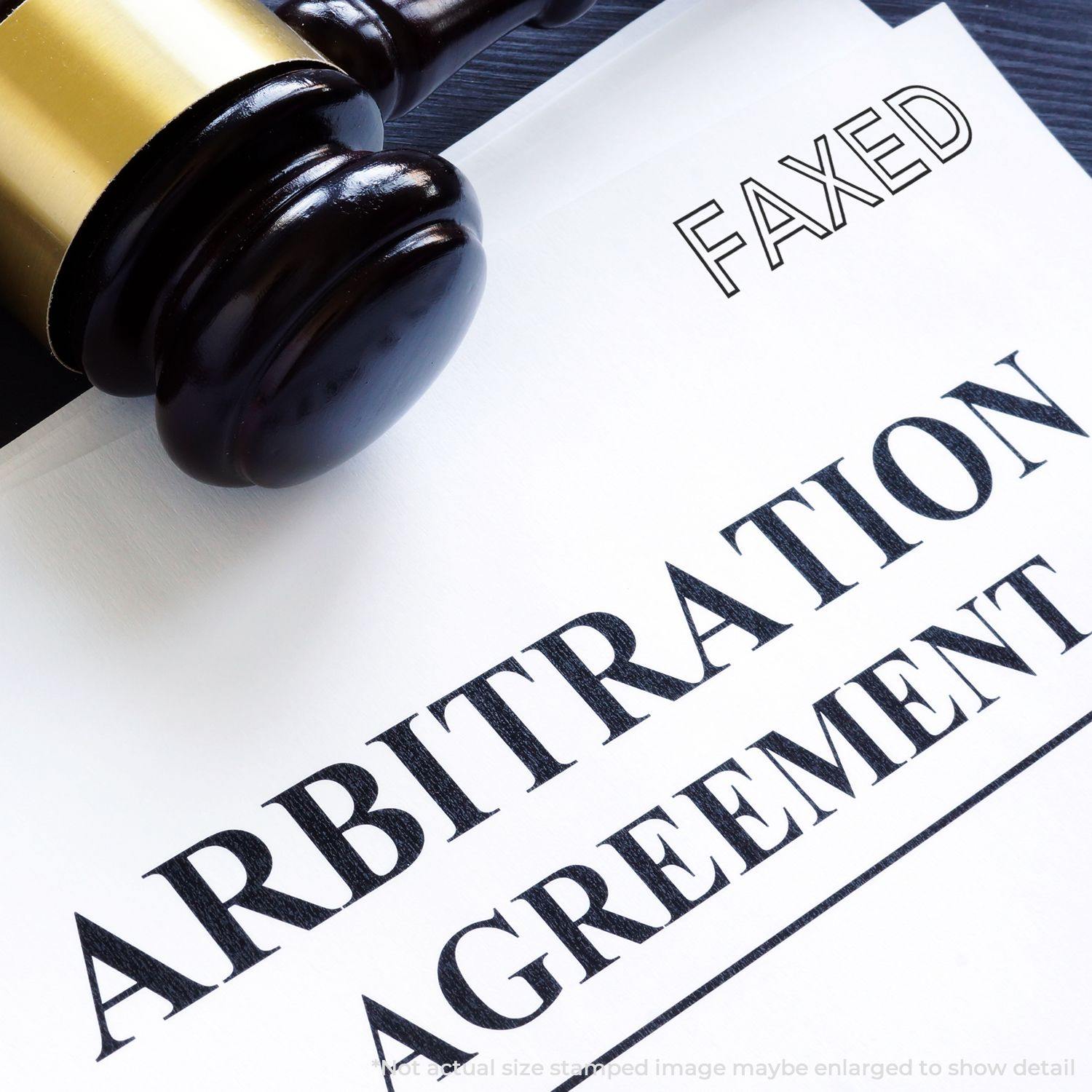 A gavel rests on an arbitration agreement document stamped with FAXED using a Faxed Rubber Stamp.