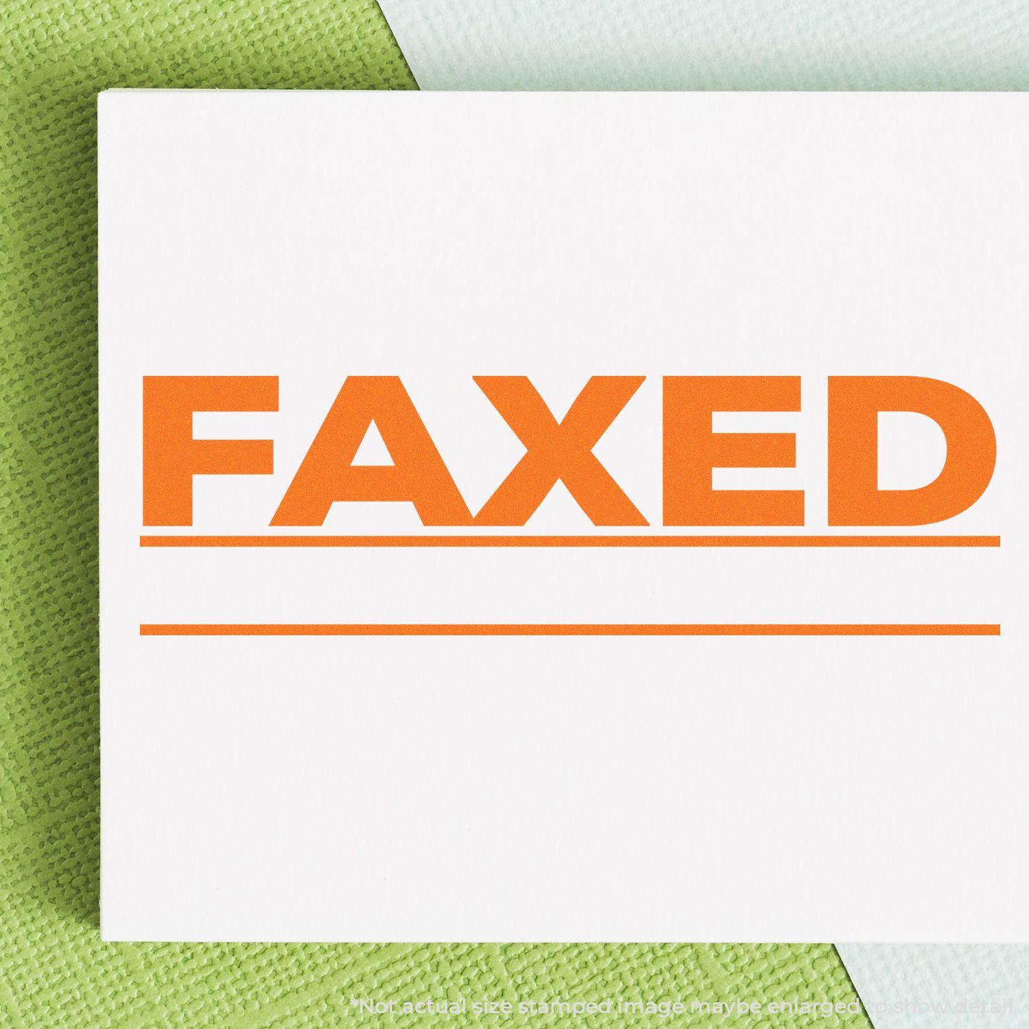 A self-inking stamp with a stamped image showing how the text "FAXED" with two lines below the text is displayed after stamping.
