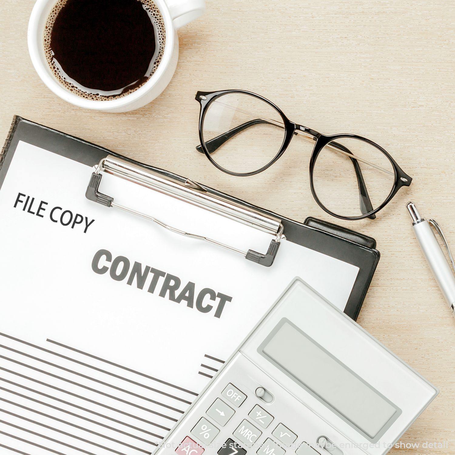 Clipboard with FILE COPY stamped on a contract, next to a cup of coffee, glasses, pen, and calculator. Product: File Copy Rubber Stamp.