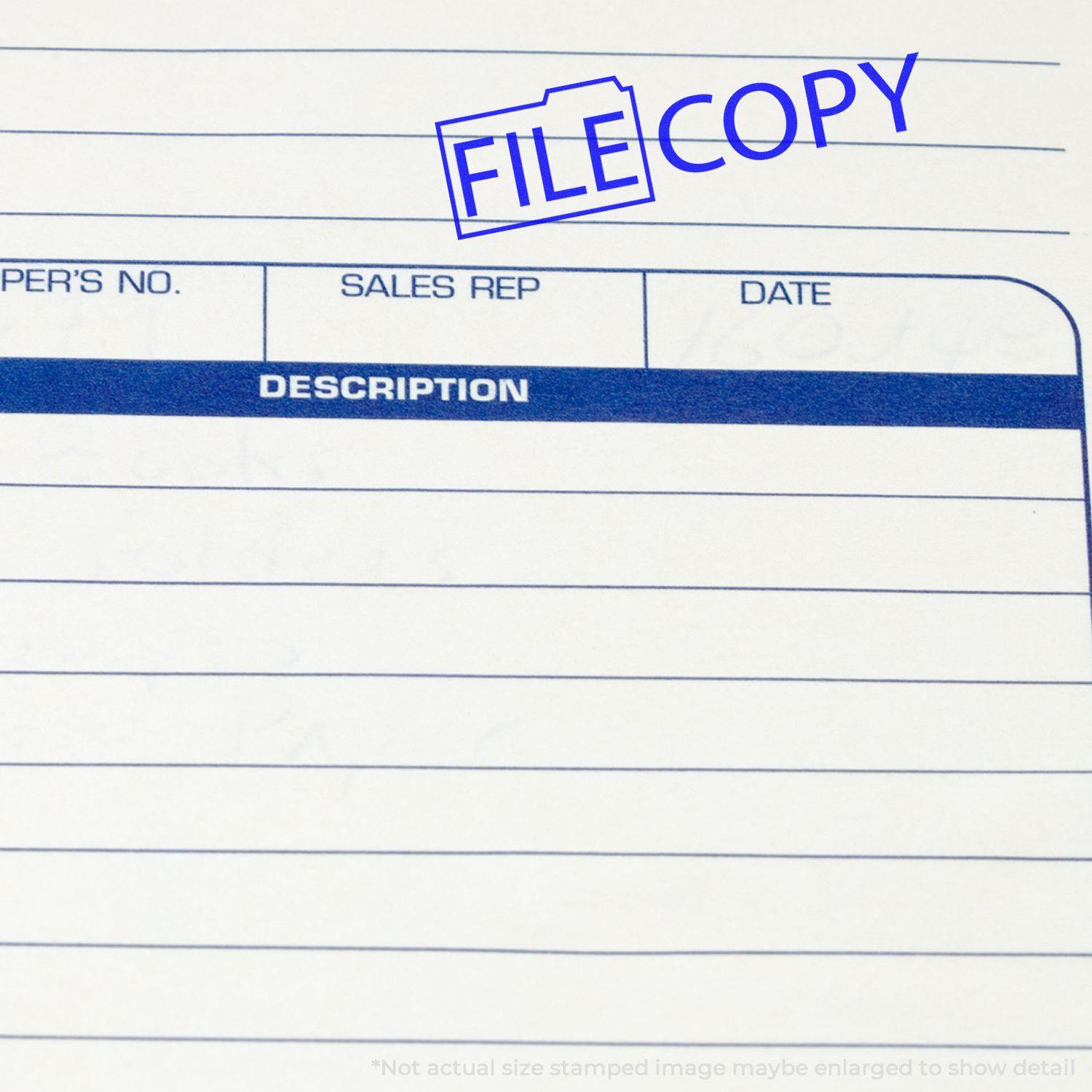 Self Inking File Copy with Folder Stamp marking a document with a blue FILE COPY stamp on a form with columns for sales rep and date.