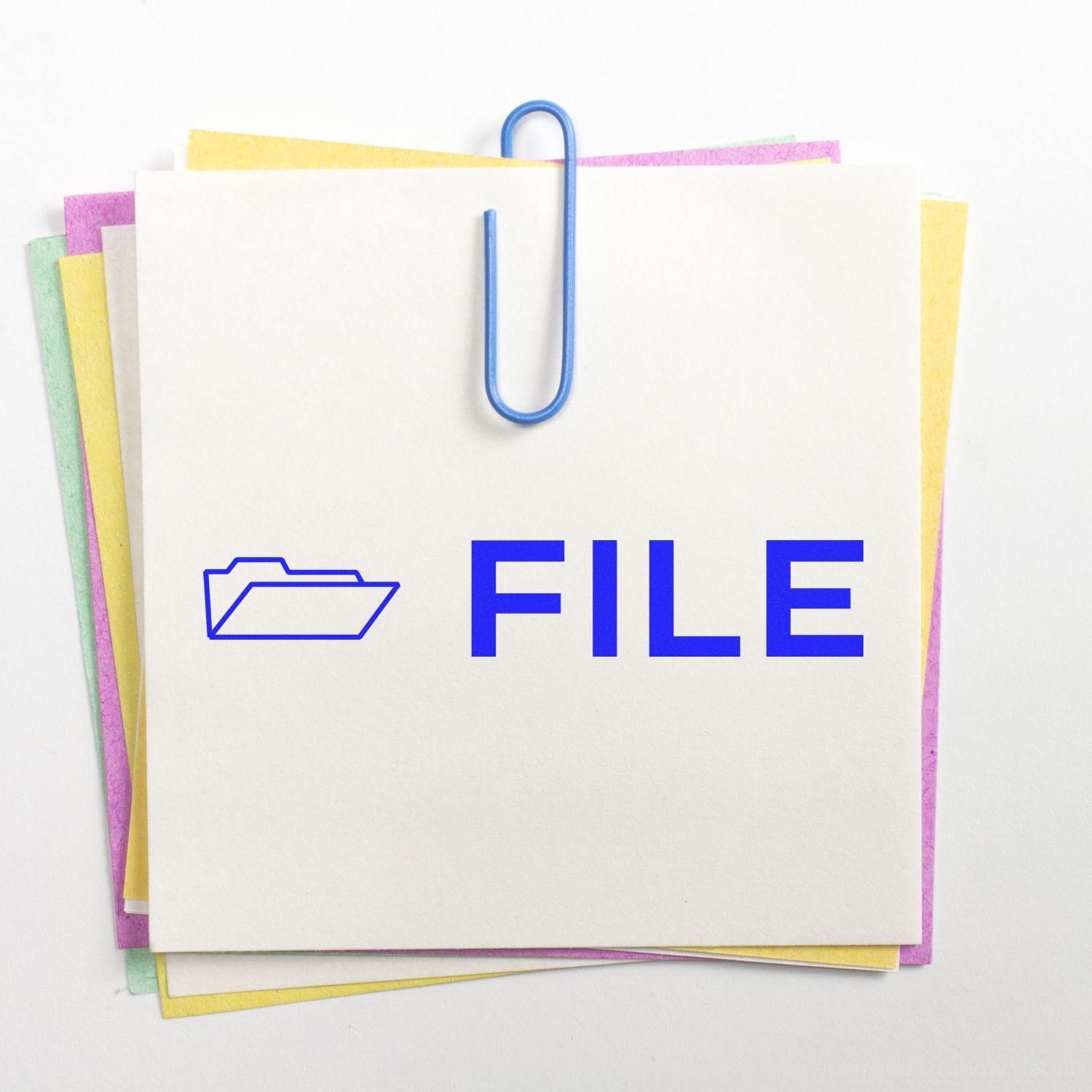 File with Folder Rubber Stamp on a stack of colorful papers, secured with a blue paperclip.