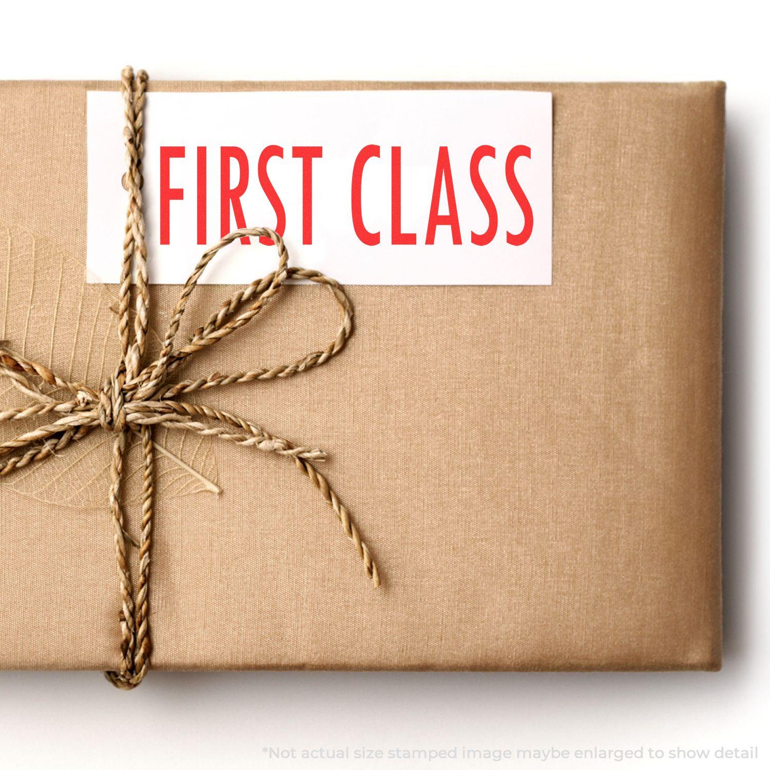 A brown package tied with twine, stamped with FIRST CLASS using the Large Self Inking First Class Stamp.