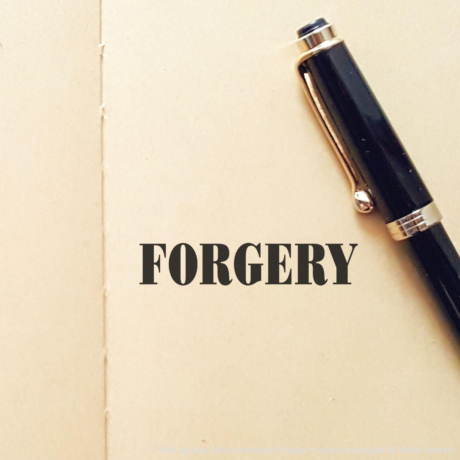 Large Self Inking Forgery Stamp imprint on a beige paper with a black pen beside it.