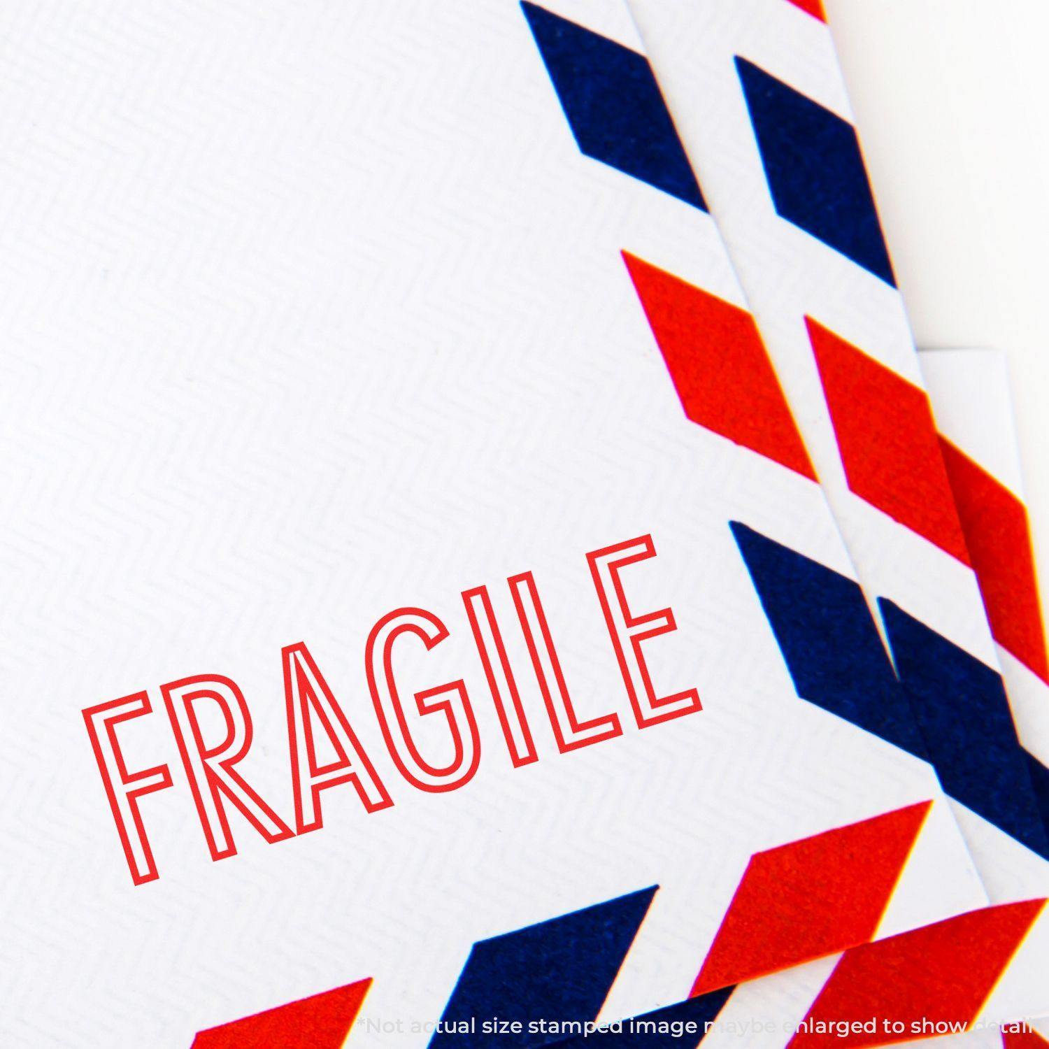 Close-up of an envelope with a red FRAGILE stamp from the Fragile Rubber Stamp, featuring red and blue airmail border design.