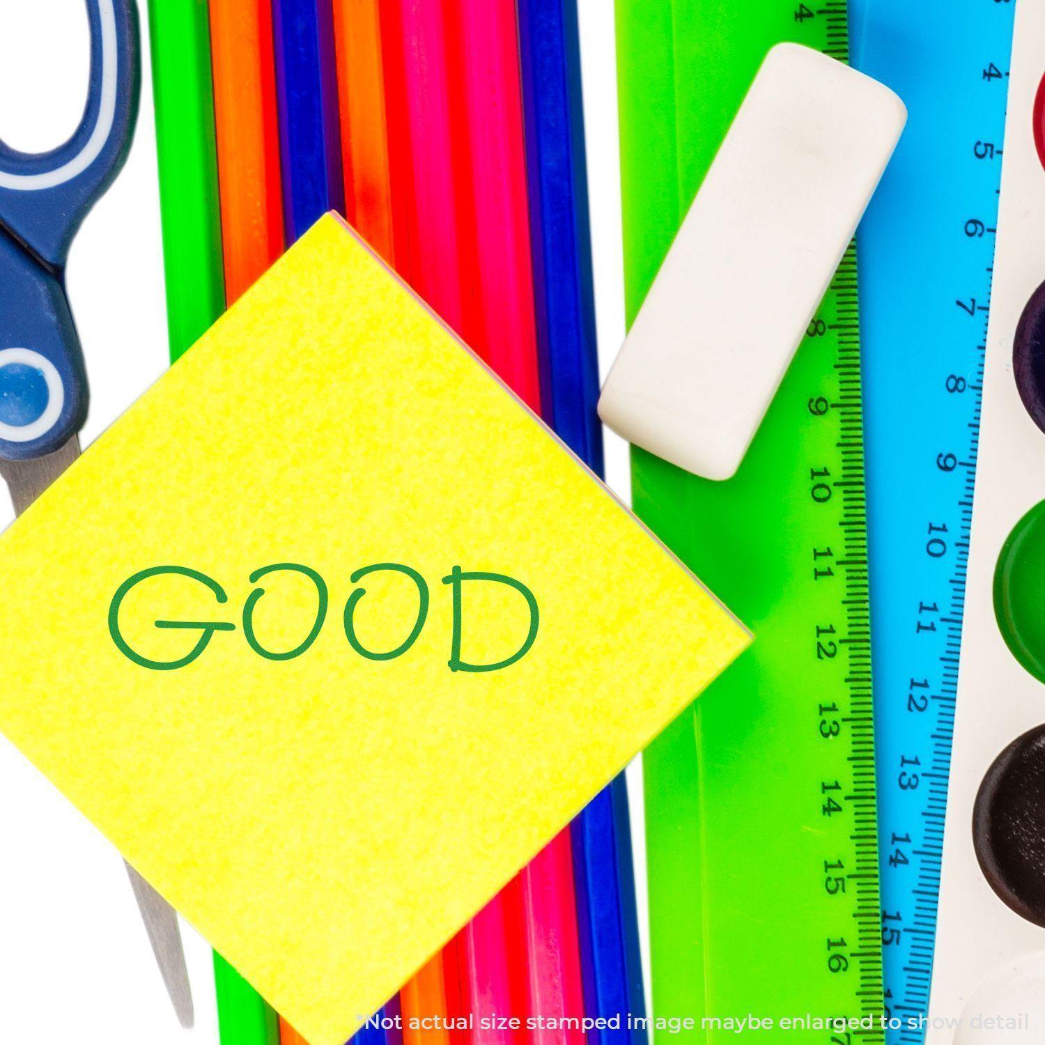 Large Self Inking Good Stamp used on a yellow sticky note, surrounded by colorful stationery items including scissors, ruler, and eraser.