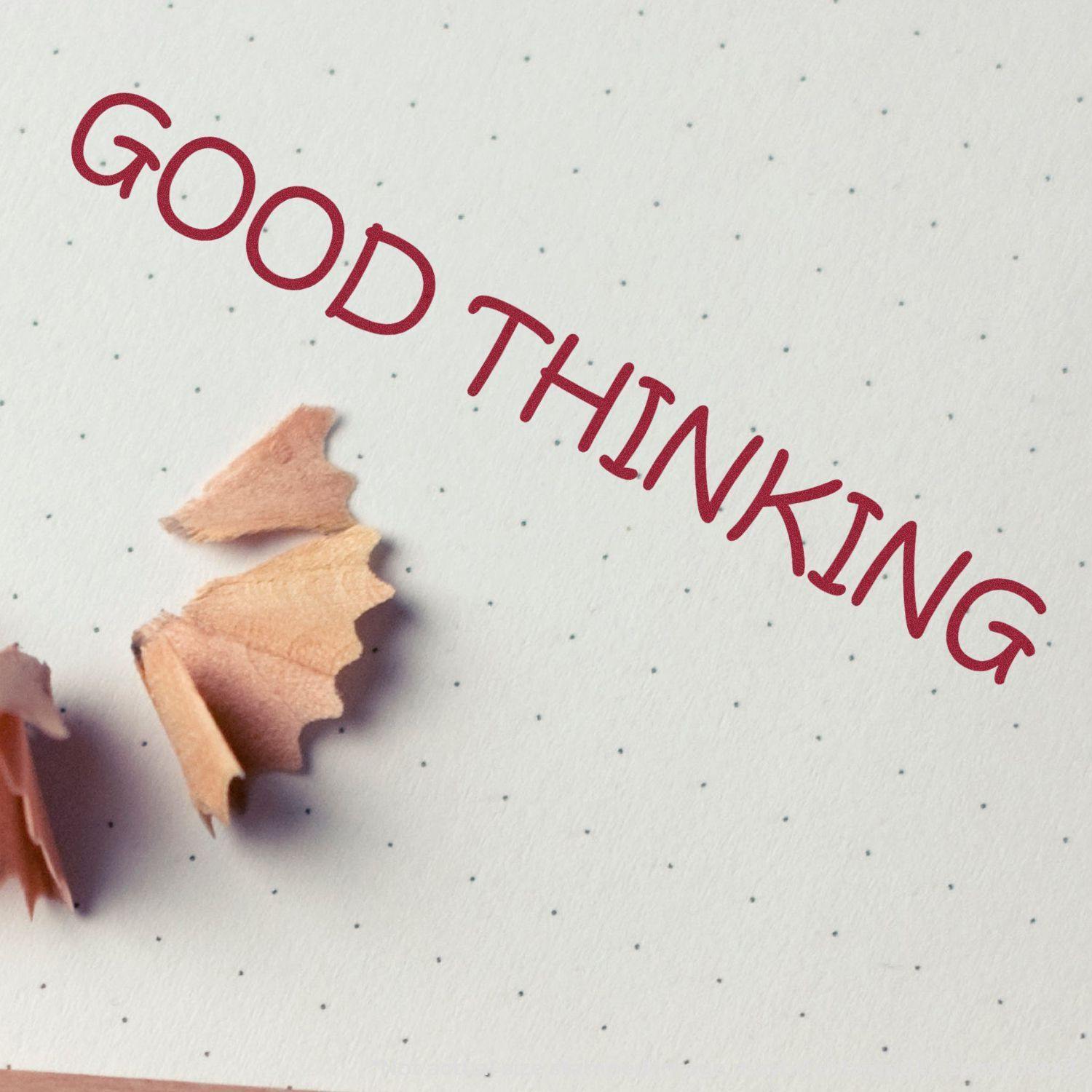 Paper with pencil shavings and a 'GOOD THINKING' impression made by a Slim Pre-Inked Good Thinking Stamp in red ink.