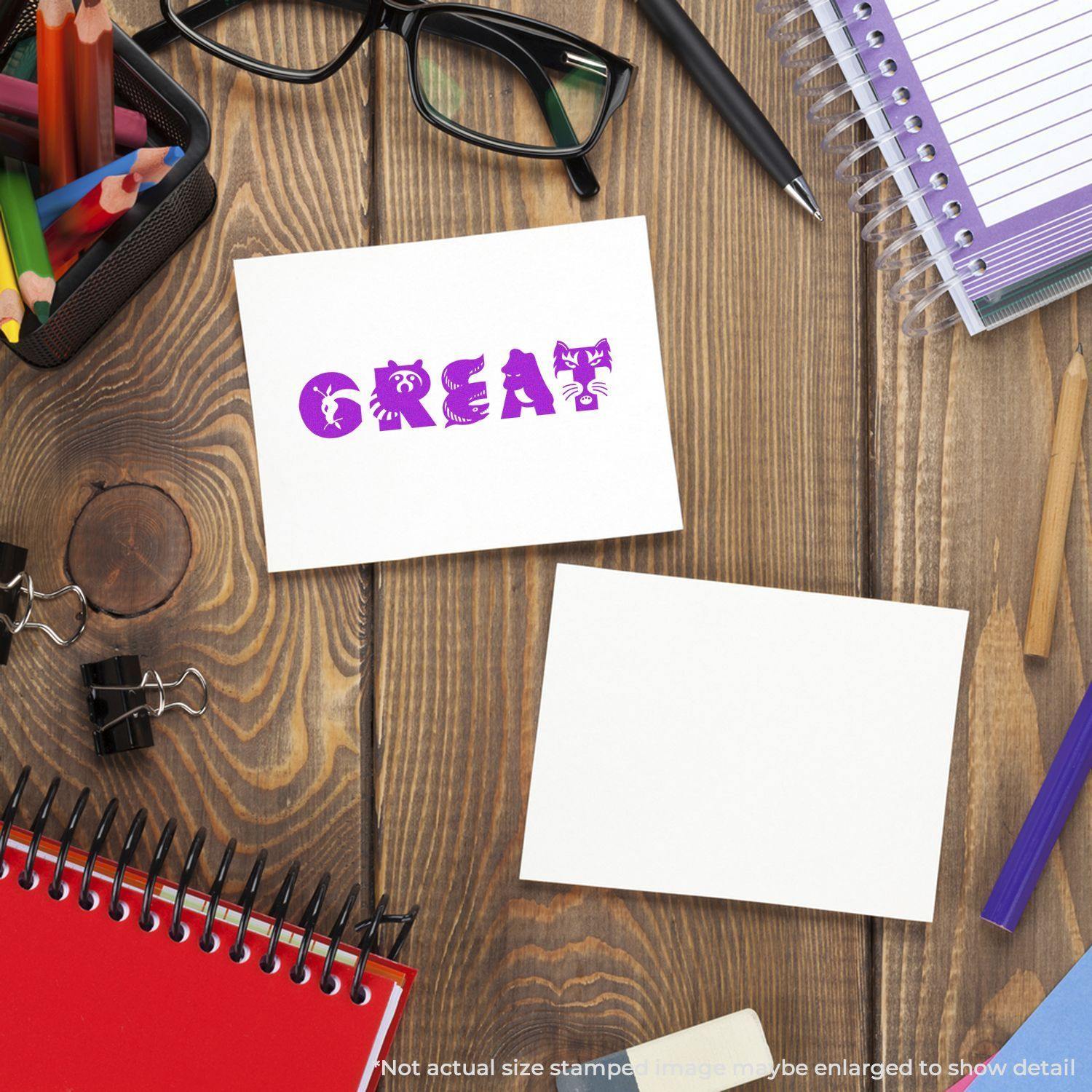 Large Pre-Inked Great Stamp used on a card, surrounded by office supplies like notebooks, glasses, and pens on a wooden desk.