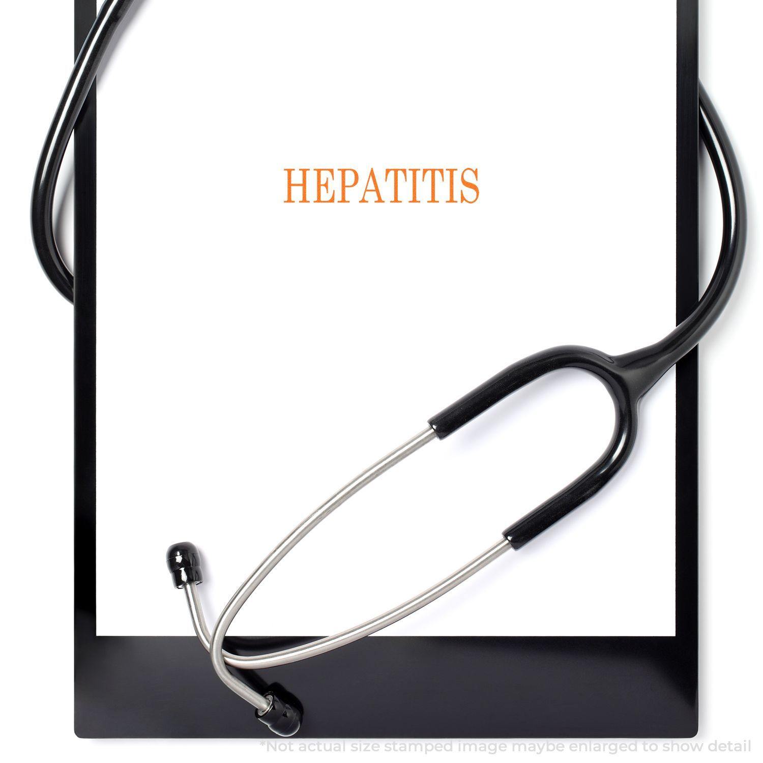 Slim Pre-Inked Hepatitis Stamp marking HEPATITIS on a white paper with a stethoscope placed around the clipboard.