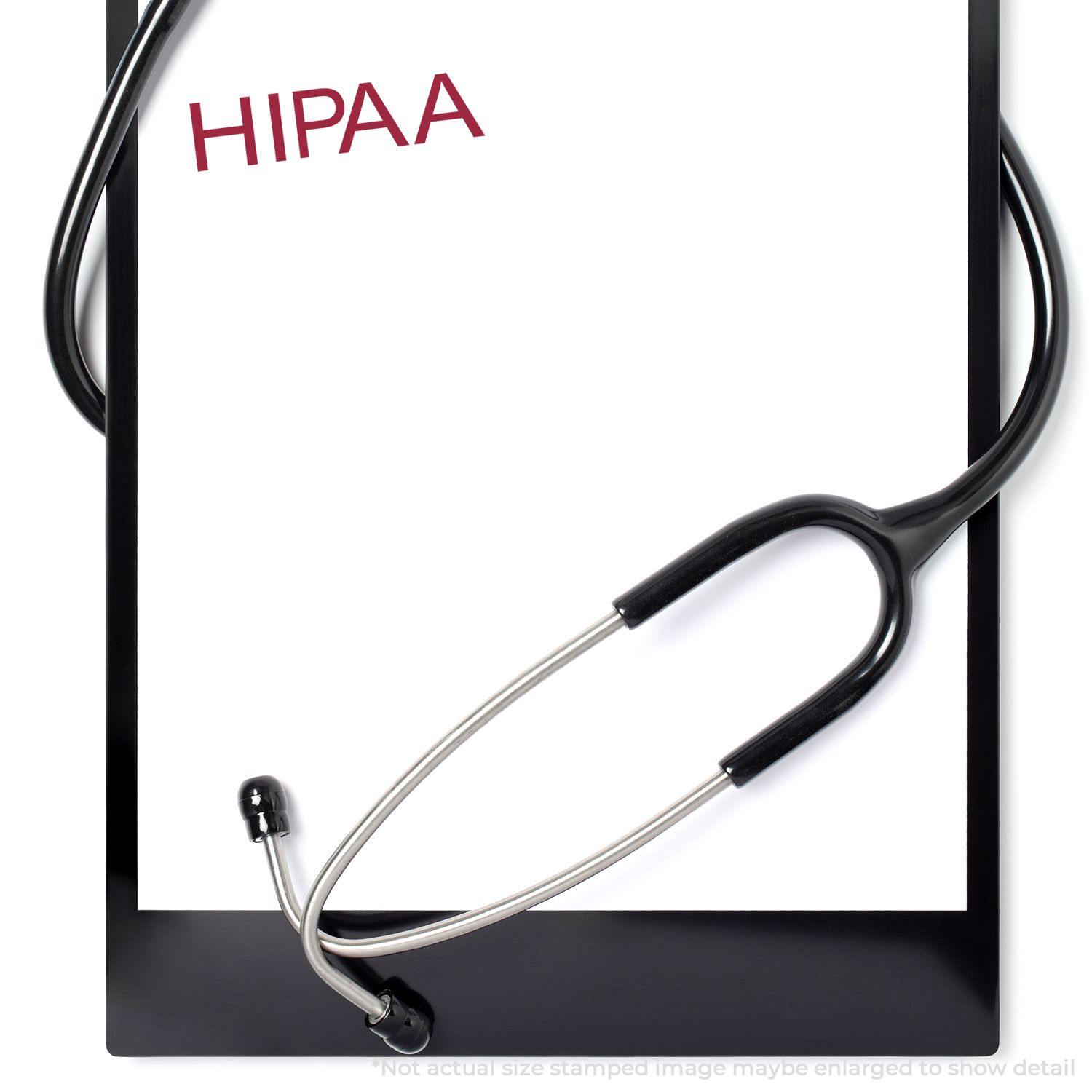 HIPAA Medical Rubber Stamp imprint on a white paper with a stethoscope on a clipboard.